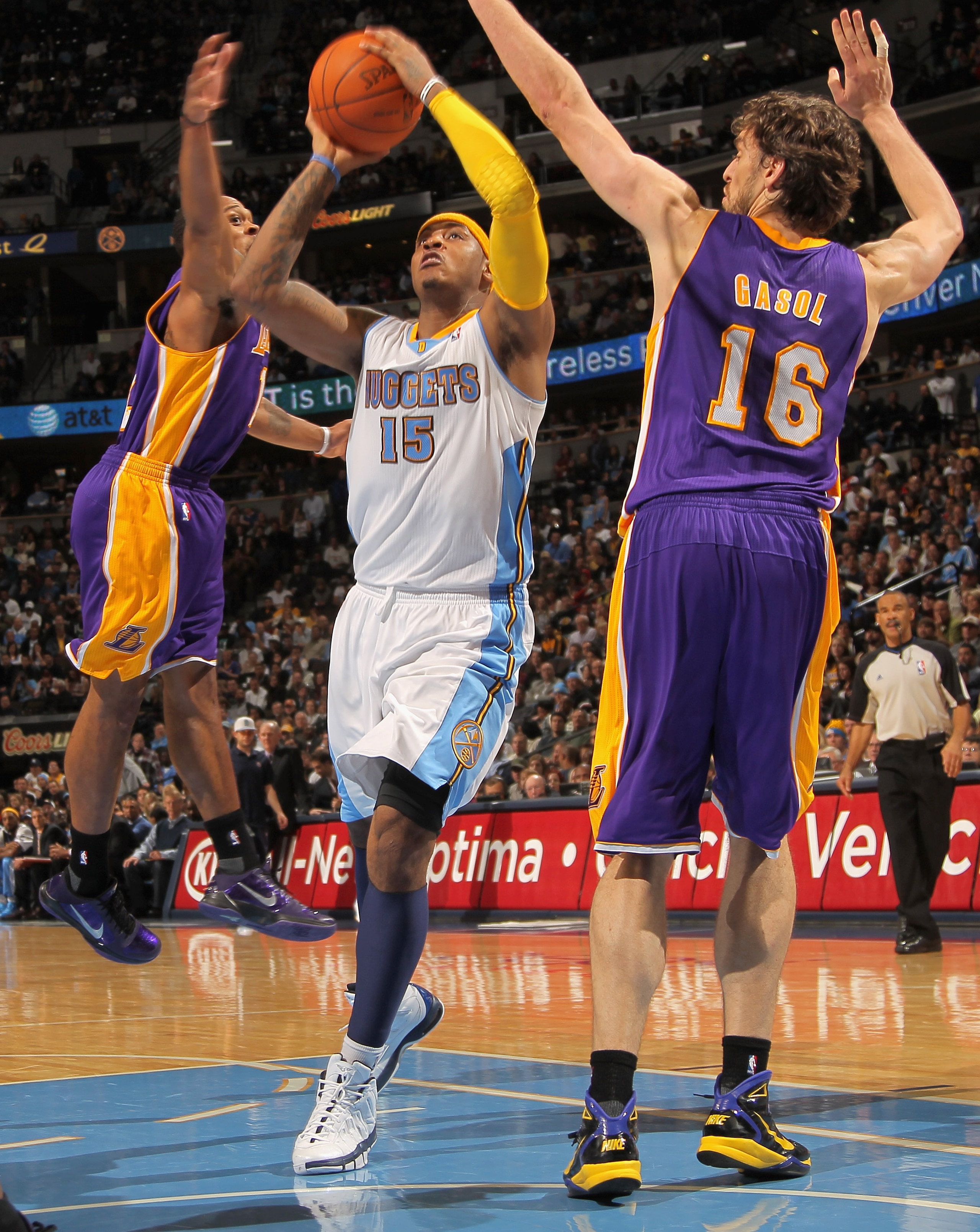 DENVER - NOVEMBER 11:  Carmelo Anthony #15 of the Denver Nuggets lays up a shot between Shannon Brown #12 and Paul Gasol #16 of the Los Angeles Lakers at the Pepsi Center on November 11, 2010 in Denver, Colorado. The Nuggets defeated the Lakers 118-112.