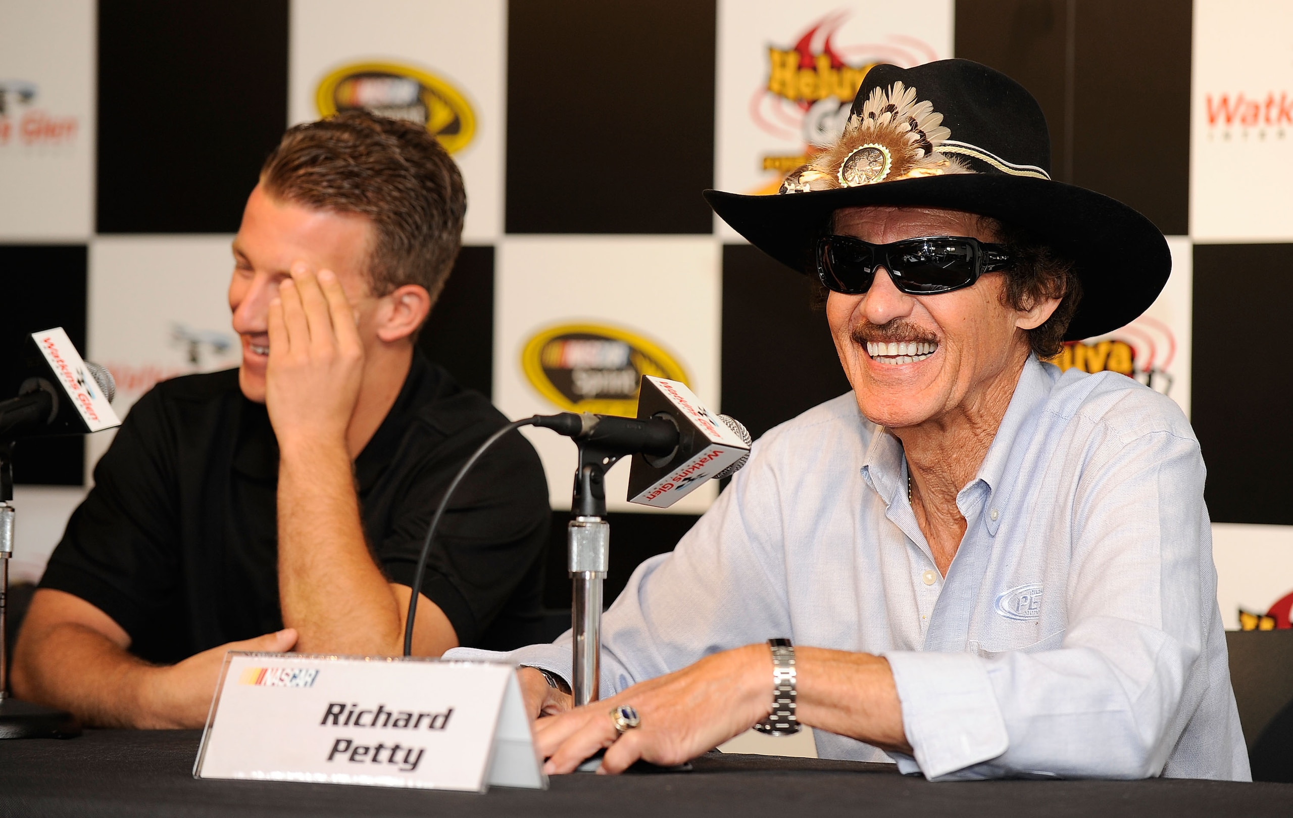 WATKINS GLEN, NY - AUGUST 06:  A.J. Allmendinger (L), driver of the #43 Insignia HDTV Ford, and Team owner Richard Petty (R) speak to the media prior to the NASCAR Heluva Good! Sour Cream Dips at The Glen on August 6, 2010 in Watkins Glen, New York.  (Pho