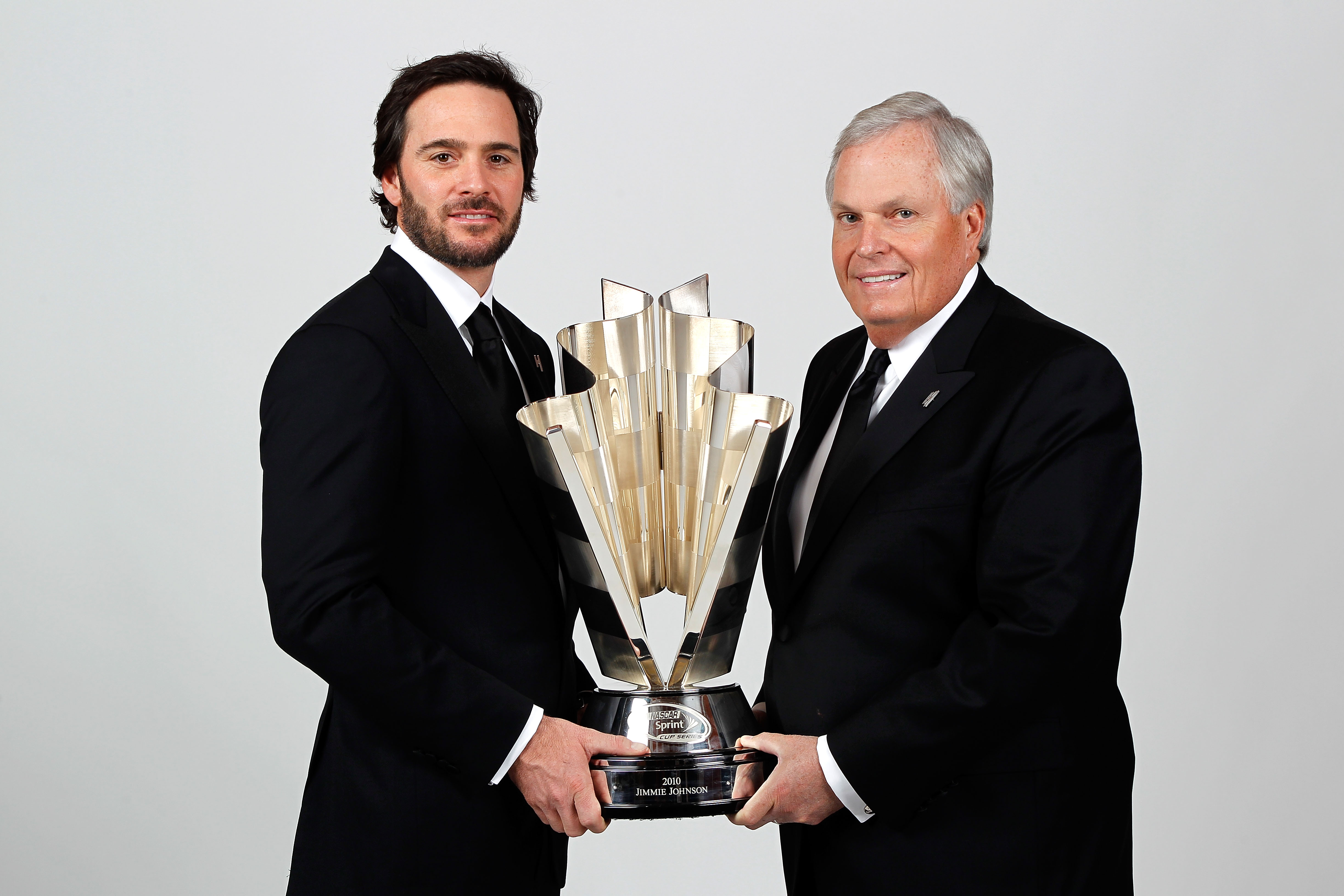 LAS VEGAS, NV - DECEMBER 03:  (L-R) Five-time champion Jimmie Johnson poses with team owner Rick Hendrick and the Sprint Cup trophy during the NASCAR Sprint Cup Series awards banquet at the Wynn Las Vegas Hotel on December 3, 2010 in Las Vegas, Nevada.  (