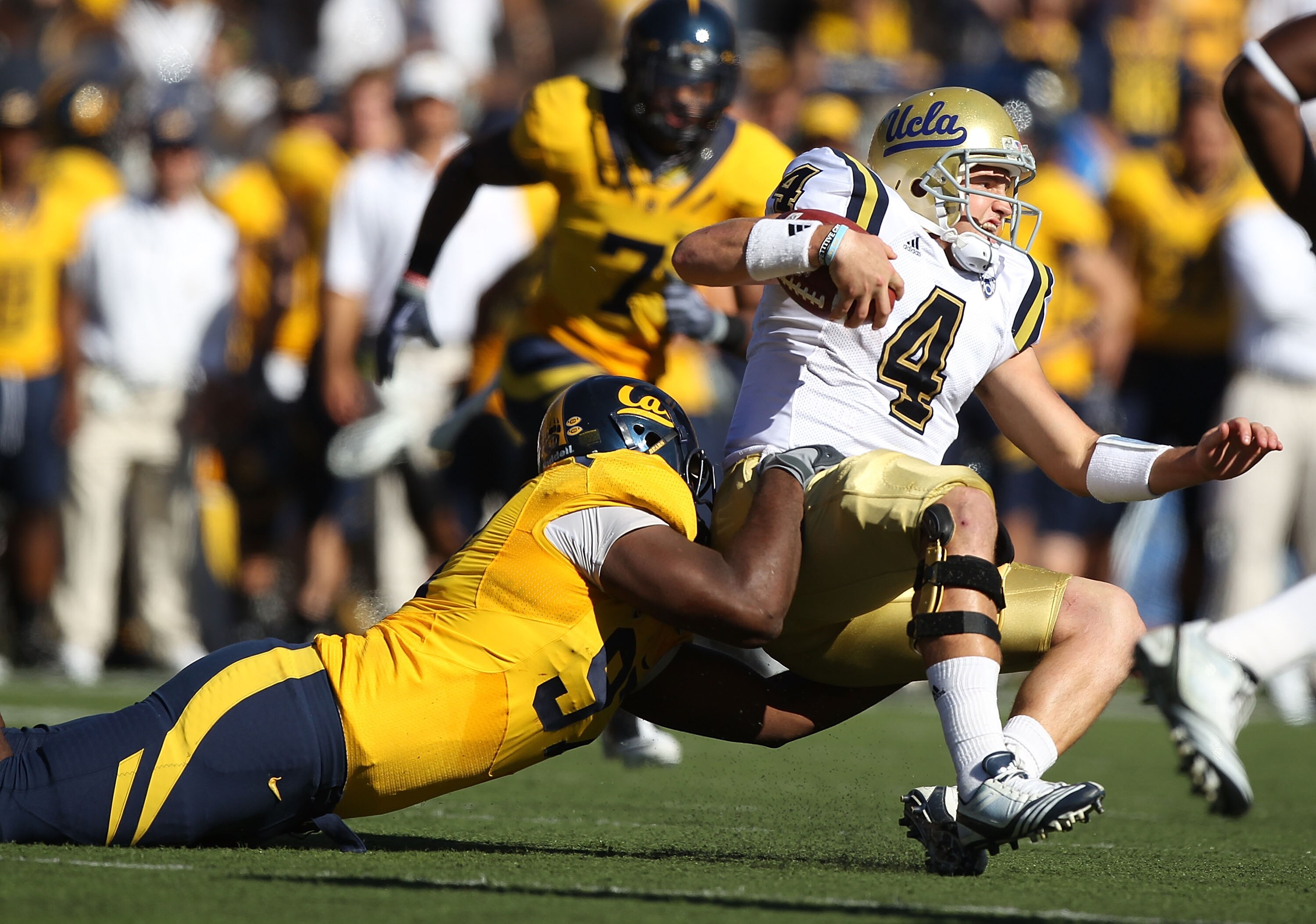 BERKELEY, CA - OCTOBER 09:  Kevin Price #4 of the UCLA Bruins is tackled by Cameron Jordan #97 of the California Golden Bears at California Memorial Stadium on October 9, 2010 in Berkeley, California.  (Photo by Jed Jacobsohn/Getty Images)