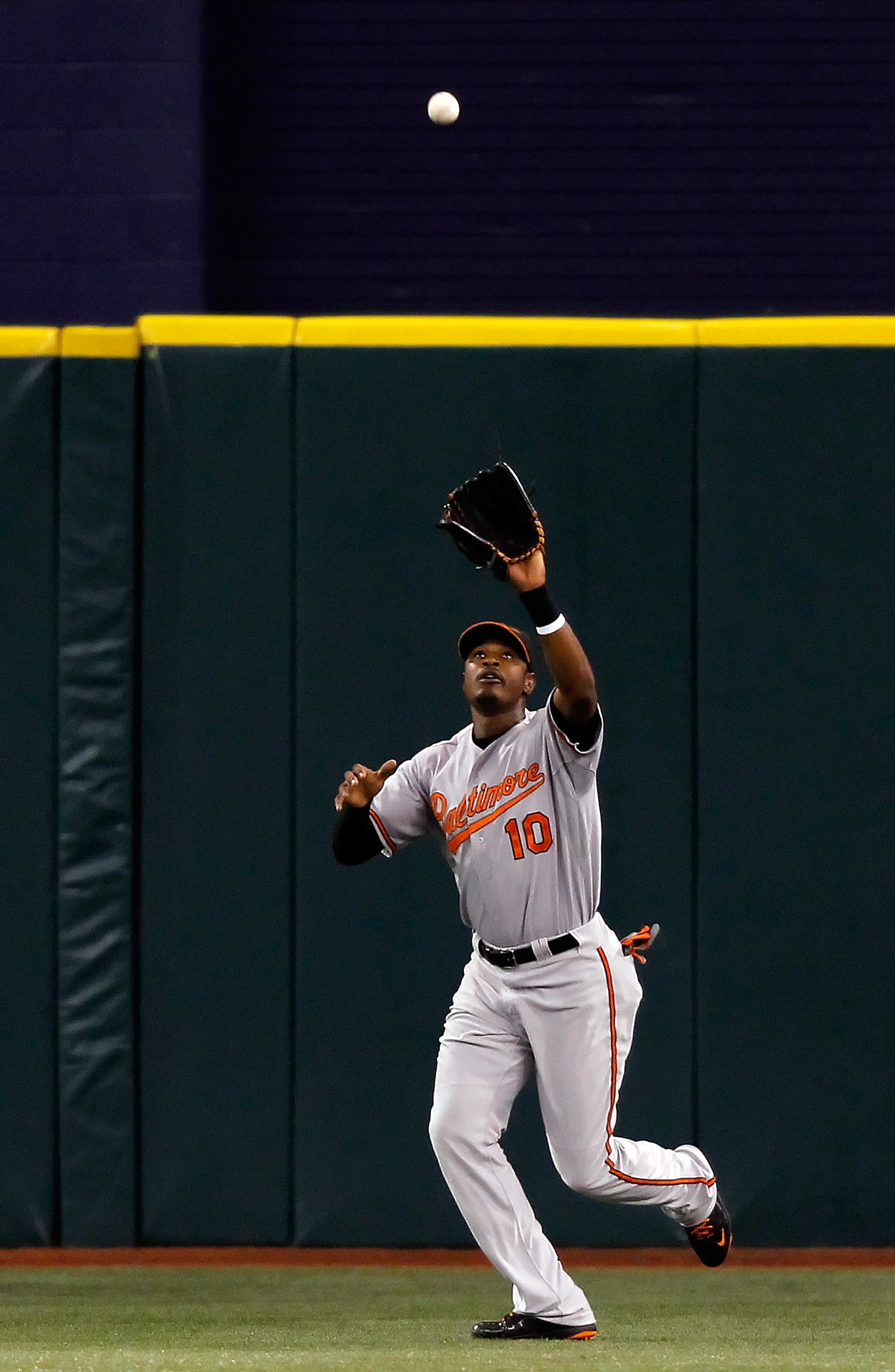 ST. PETERSBURG, FL - SEPTEMBER 28:  Outfielder Adam Jones #10 of the Baltimore Orioles catches a fly ball against the Tampa Bay Rays during the game at Tropicana Field on September 28, 2010 in St. Petersburg, Florida.  (Photo by J. Meric/Getty Images)
