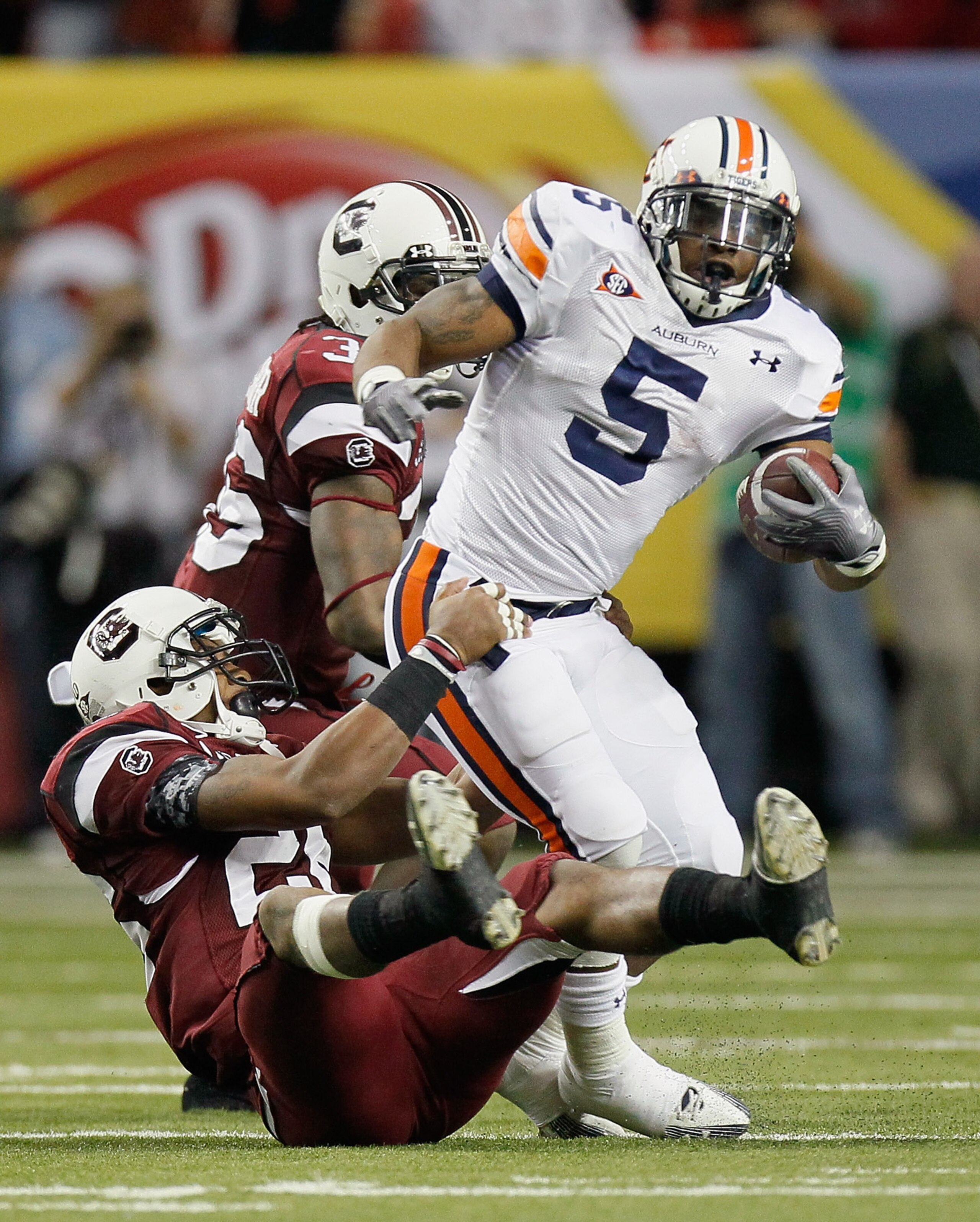 ATLANTA, GA - DECEMBER 04:  Michael Dyer #5 of the Auburn Tigers rushes is tackled by Antonio Allen #26 of the South Carolina Gamecocks during the 2010 SEC Championship at Georgia Dome on December 4, 2010 in Atlanta, Georgia.  (Photo by Kevin C. Cox/Getty