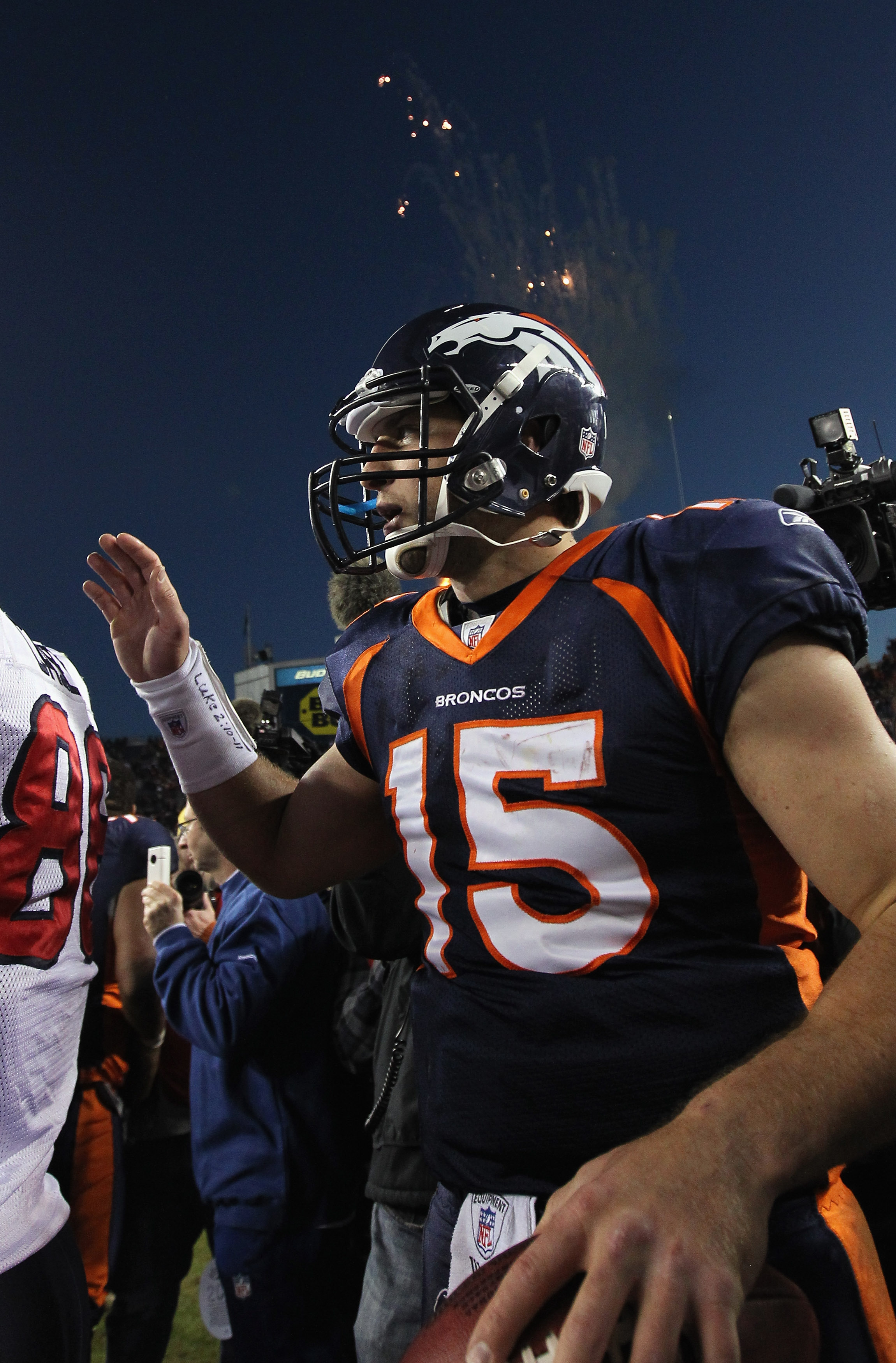 DENVER - DECEMBER 26:  Quarterback Tim Tebow #15 of the Denver Broncos greets members of the Houston Texas at midfield after the game at INVESCO Field at Mile High on December 26, 2010 in Denver, Colorado. The Broncos defeated the Texans 24-23.  (Photo by