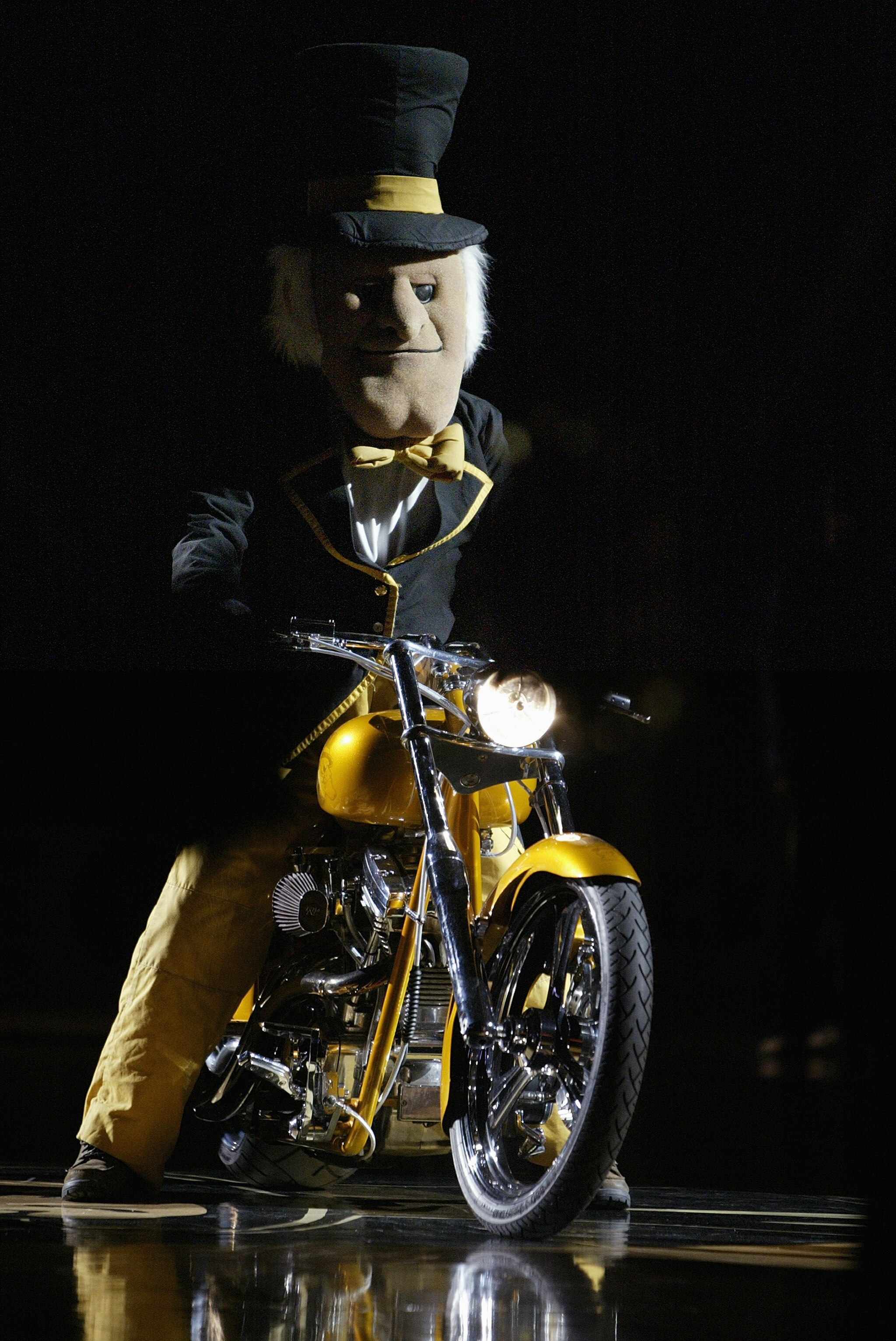WINSTON-SALEM, NC - FEBRUARY 18:  The Deacon, the mascot of the Wake Forest Demon Deacons, rides a motorcycle during a break in the game against the Duke Blue Devils on February 18, 2004 at Lawrence Joel Coliseum in Winston-Salem, North Carolina. The Deac