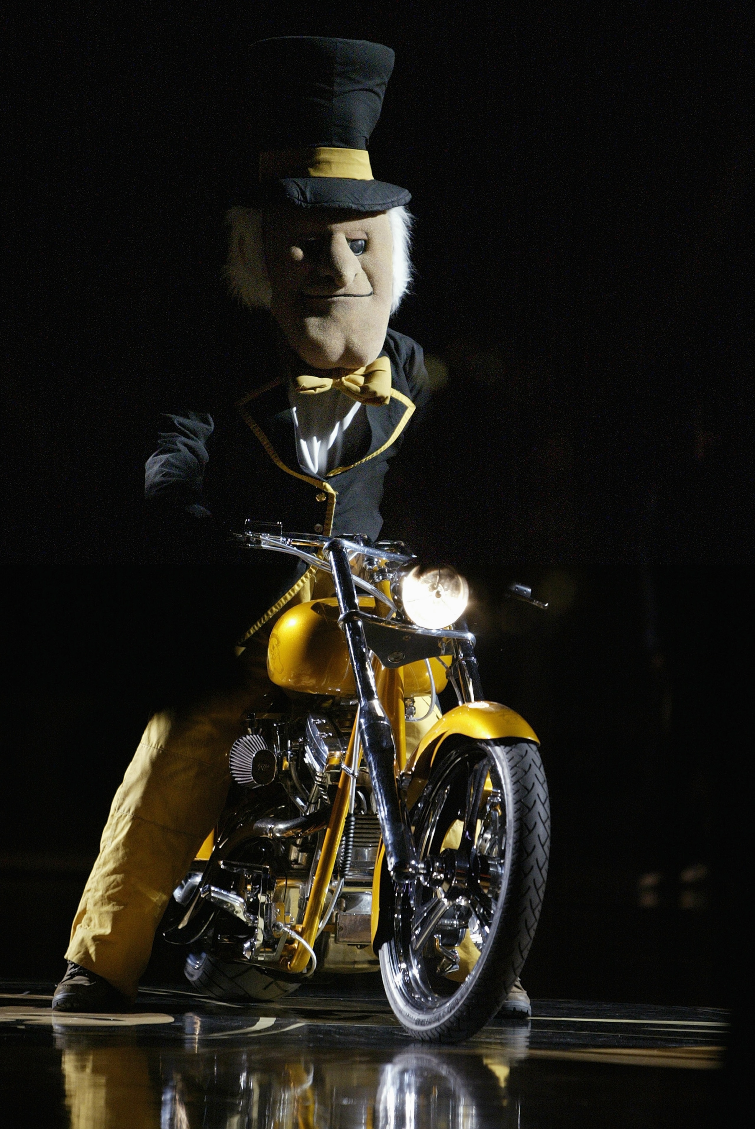 WINSTON-SALEM, NC - FEBRUARY 18: The Deacon, the mascot of the Wake Forest Demon Deacons, rides a motorcycle during a break in the game against the Duke Blue Devils on February 18, 2004 at Lawrence Joel Coliseum in Winston-Salem, North Carolina. The Deac WINSTON-SALEM, NC - FEBRUARY 18: The Deacon, the mascot of the Wake Forest Demon Deacons, rides a motorcycle during a break in the game against the Duke Blue Devils on February 18, 2004 at Lawrence Joel Coliseum in Winston-Salem, North Carolina. The Deac