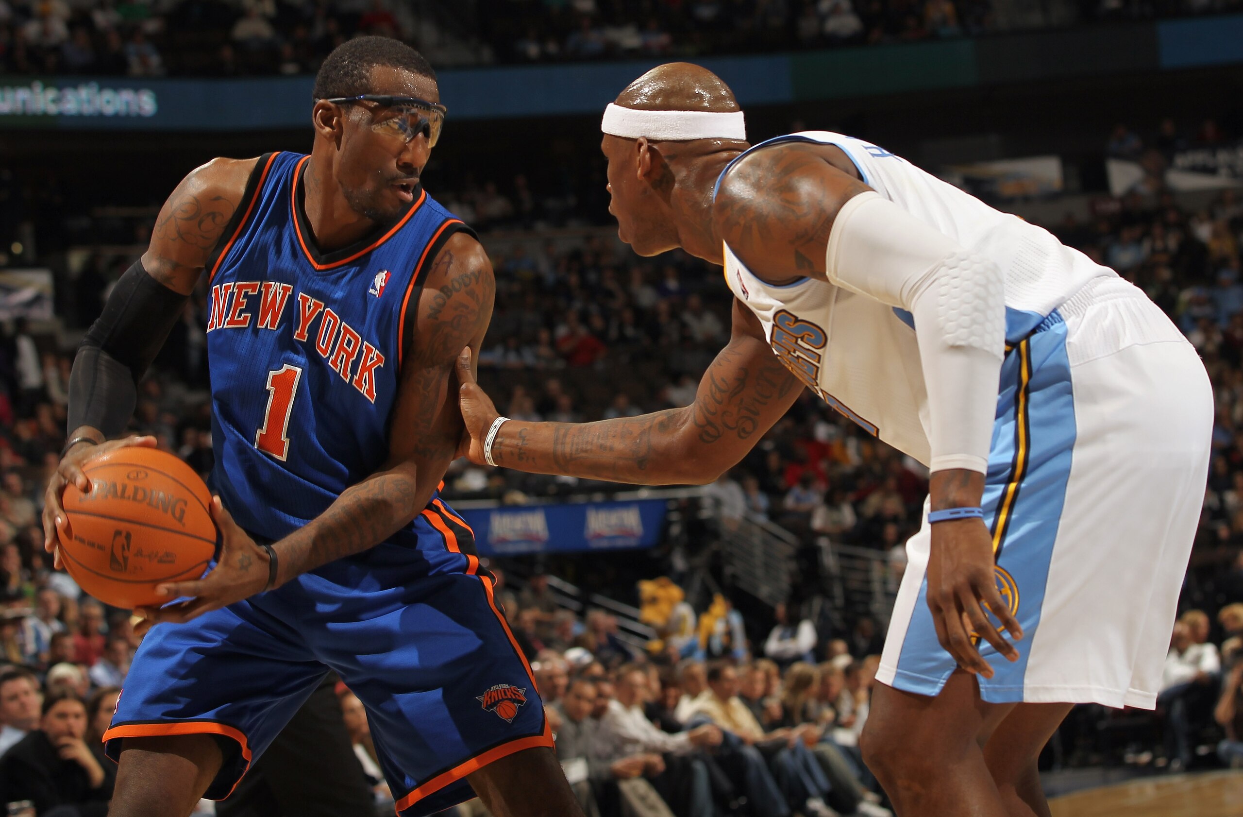 DENVER - NOVEMBER 16:  Amar'e Stoudemire #1 of the New York Knicks controls the ball as Al Harrington #7 of the Denver Nuggets defends at the Pepsi Center on November 16, 2010 in Denver, Colorado. NOTE TO USER: User expressly acknowledges and agrees that,