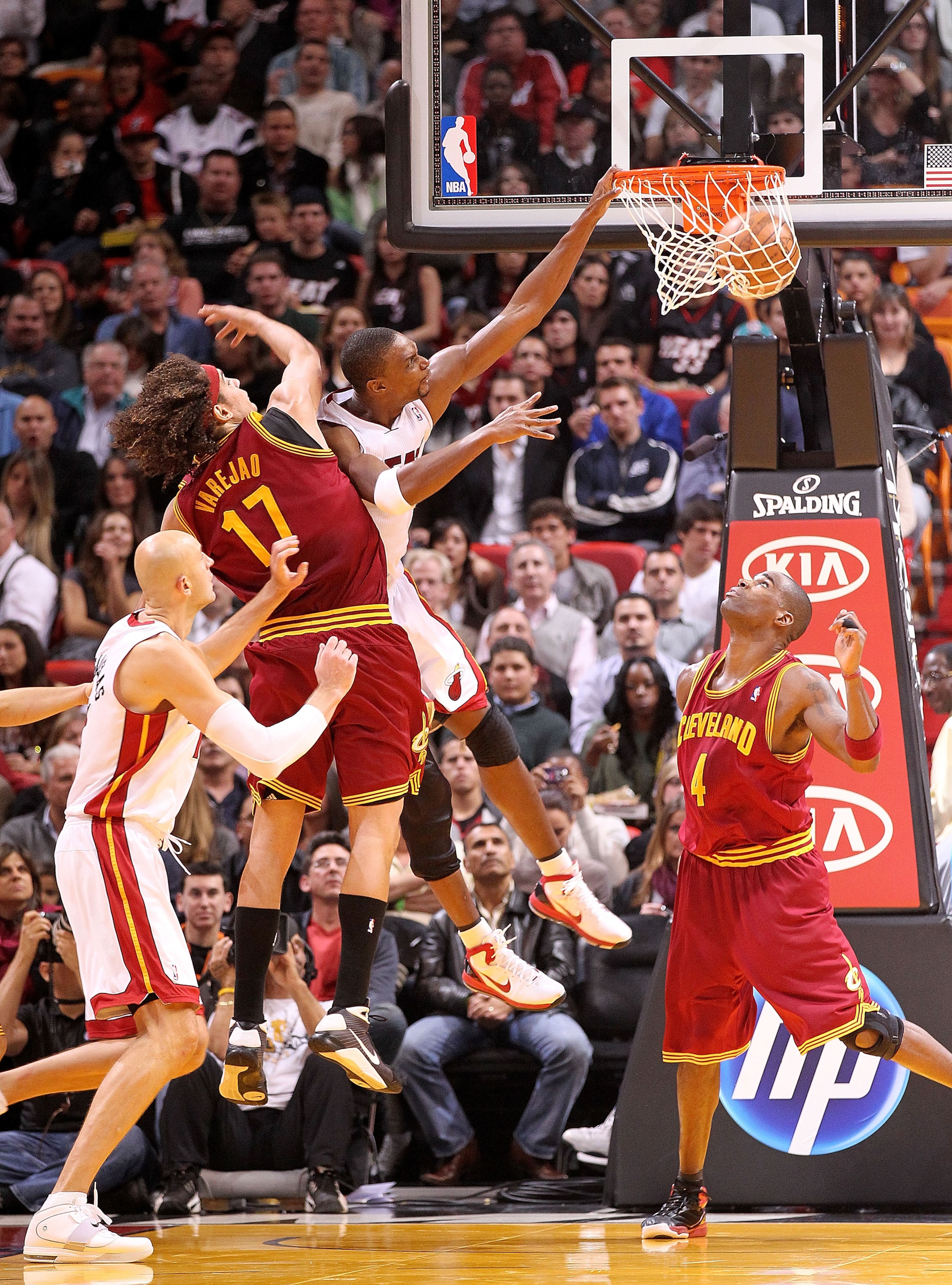 MIAMI, FL - DECEMBER 15:  Chris Bosh #1 of the Miami Heat dunks over Anderson Varejao #17 of the Cleveland Cavaliers during a game at American Airlines Arena on December 15, 2010 in Miami, Florida. NOTE TO USER: User expressly acknowledges and agrees that