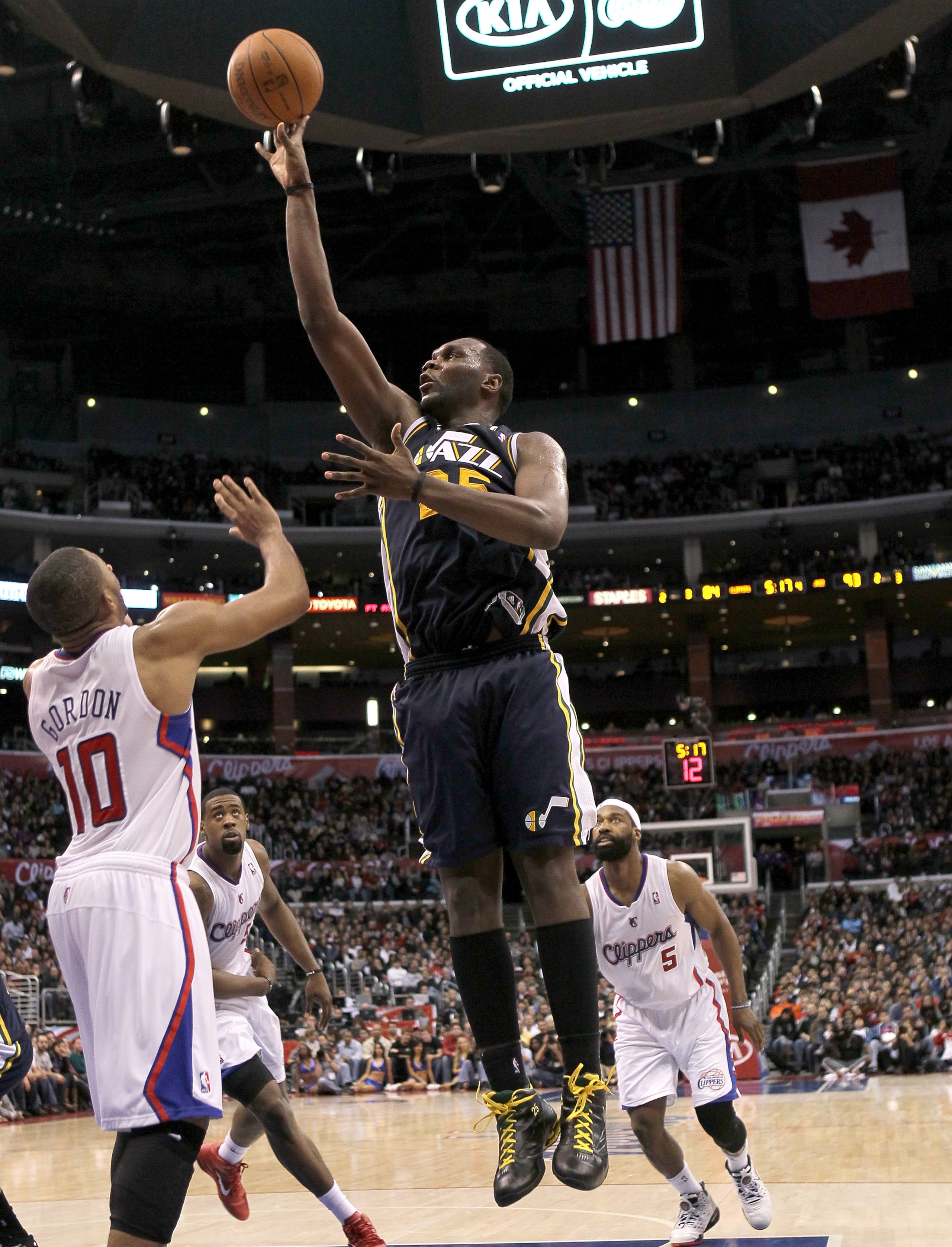 LOS ANGELES, CA - DECEMBER 29:  Al Jefferson #25 of the Utah Jazz shoots over Eric Gordon #10 of the Los Angeles Clippers at Staples Center on December 29, 2010 in Los Angeles, California.   The Jazz won 103-85.  NOTE TO USER: User expressly acknowledges