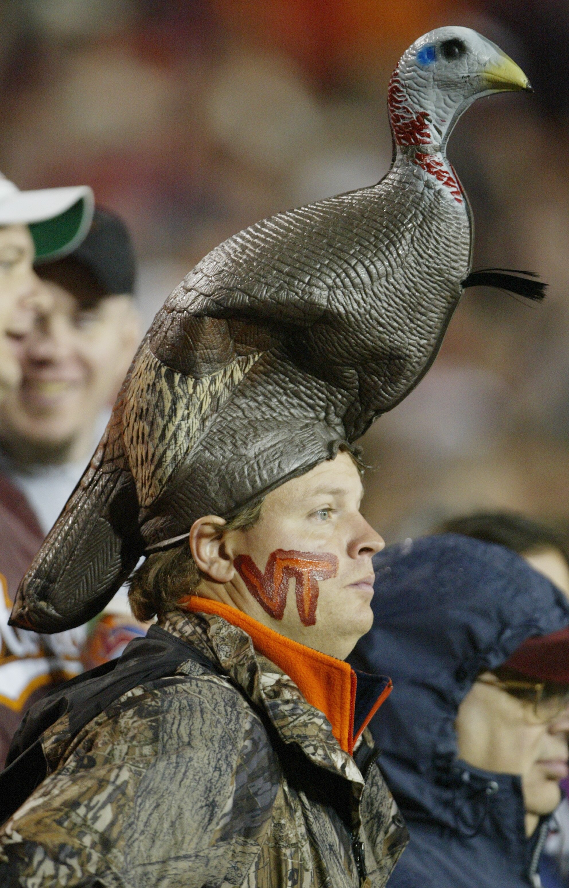 BLACKSBURG, VA - NOVEMBER 18:  A male fan of the Virginia Tech Hokies wears a HokieBird on his head as he watches the game against the Maryland Terrapins during NCAA football at Lane Stadium on November 18, 2004 in Blacksburg, Virginia. The Hokies defeate