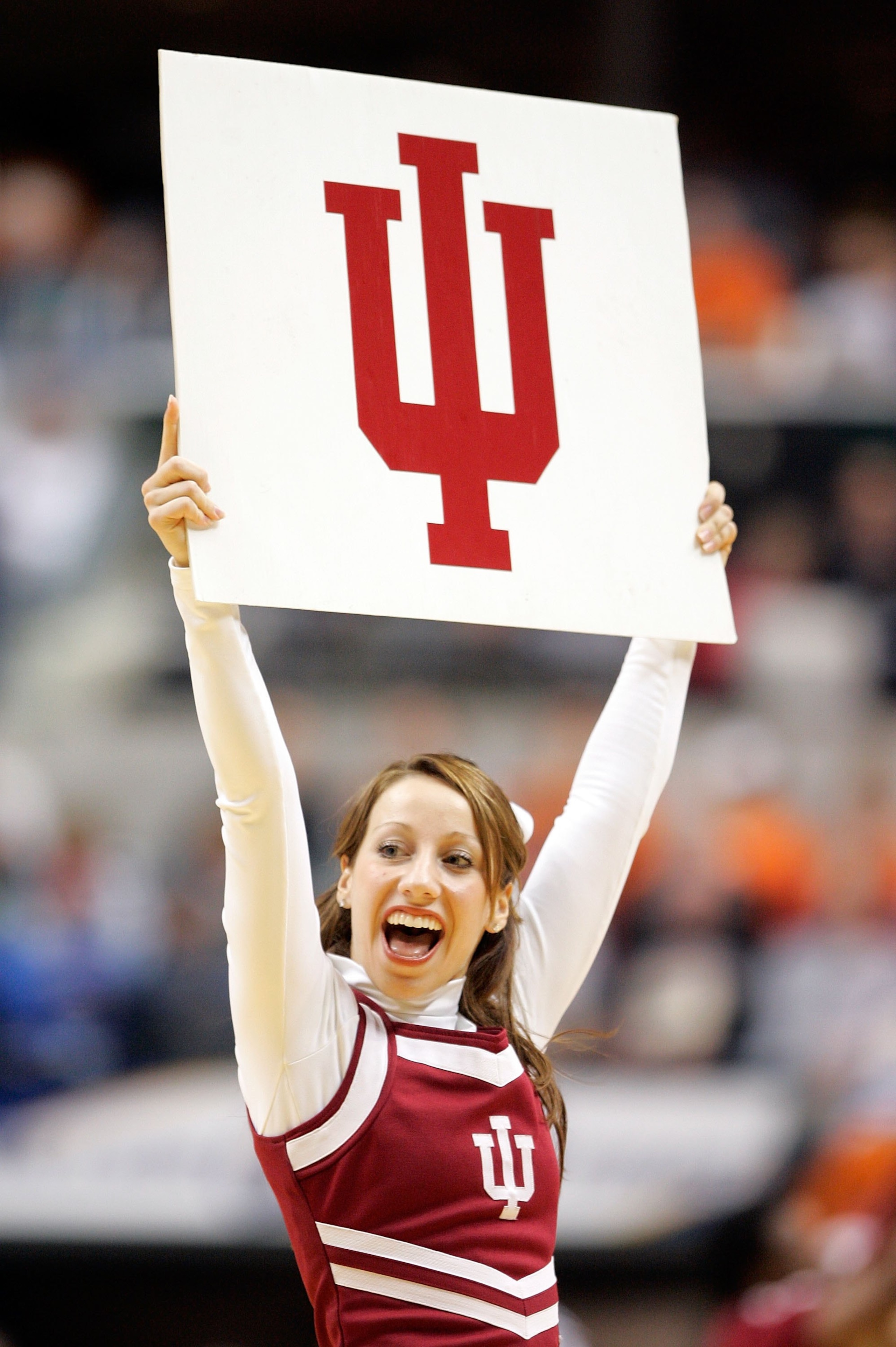 INDIANAPOLIS - MARCH 10: An Indiana Hoosiers cheerleader holds up a sign during a break in the game against the Wisconsin Badgers during Day 2 of the Big 10 Tournament on March 10, 2006 at Conseco Fieldhouse in Indianapolis, Indiana. (Photo by Brian Bah INDIANAPOLIS - MARCH 10: An Indiana Hoosiers cheerleader holds up a sign during a break in the game against the Wisconsin Badgers during Day 2 of the Big 10 Tournament on March 10, 2006 at Conseco Fieldhouse in Indianapolis, Indiana. (Photo by Brian Bah