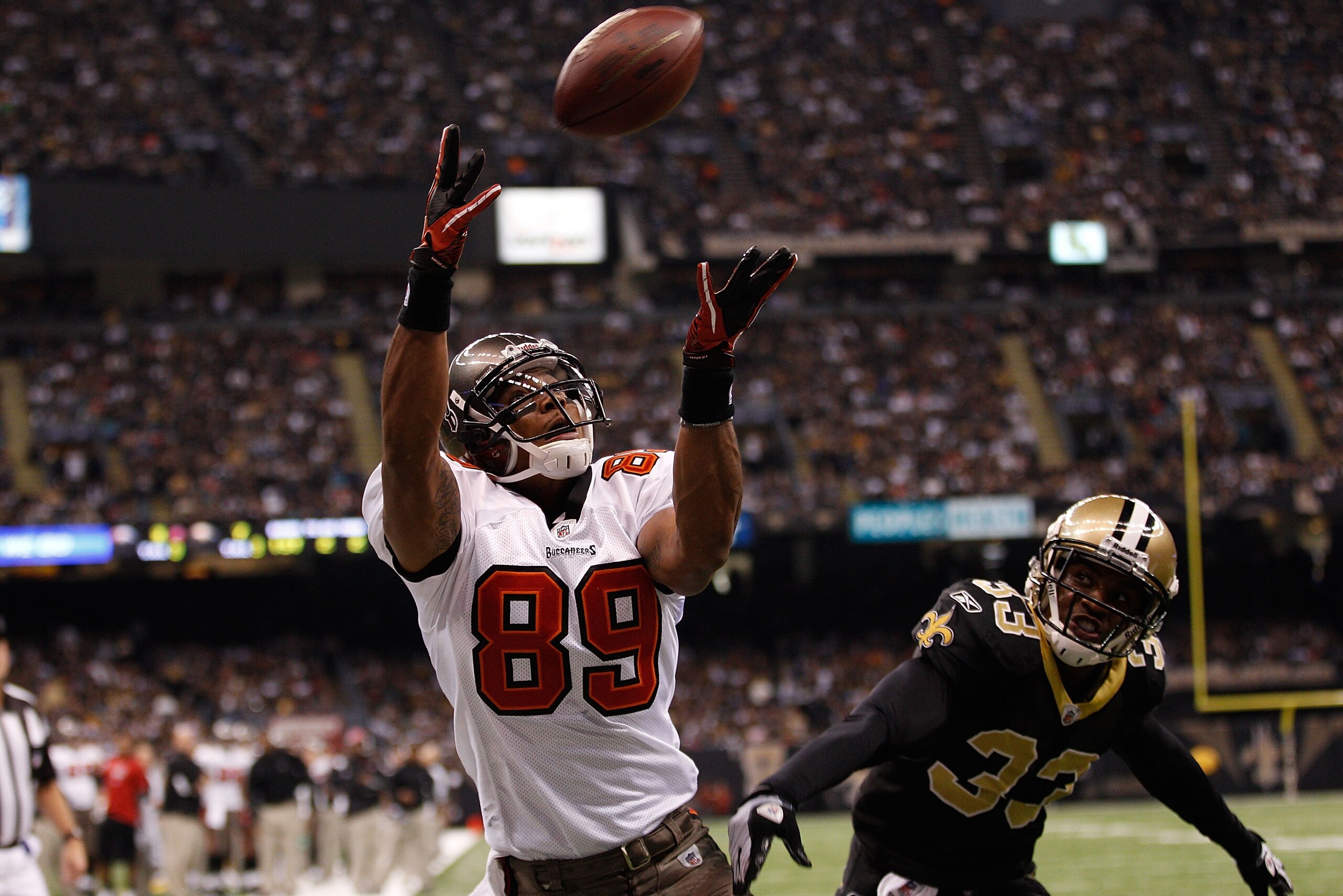 NEW ORLEANS, LA - JANUARY 02:  Dezmon Briscoe #89 of the Tampa Bay Buccaneers catches a touchdown pass over Jabari Greer #33 of the New Orleans Saints at the Louisiana Superdome on January 2, 2011 in New Orleans, Louisiana.  (Photo by Chris Graythen/Getty
