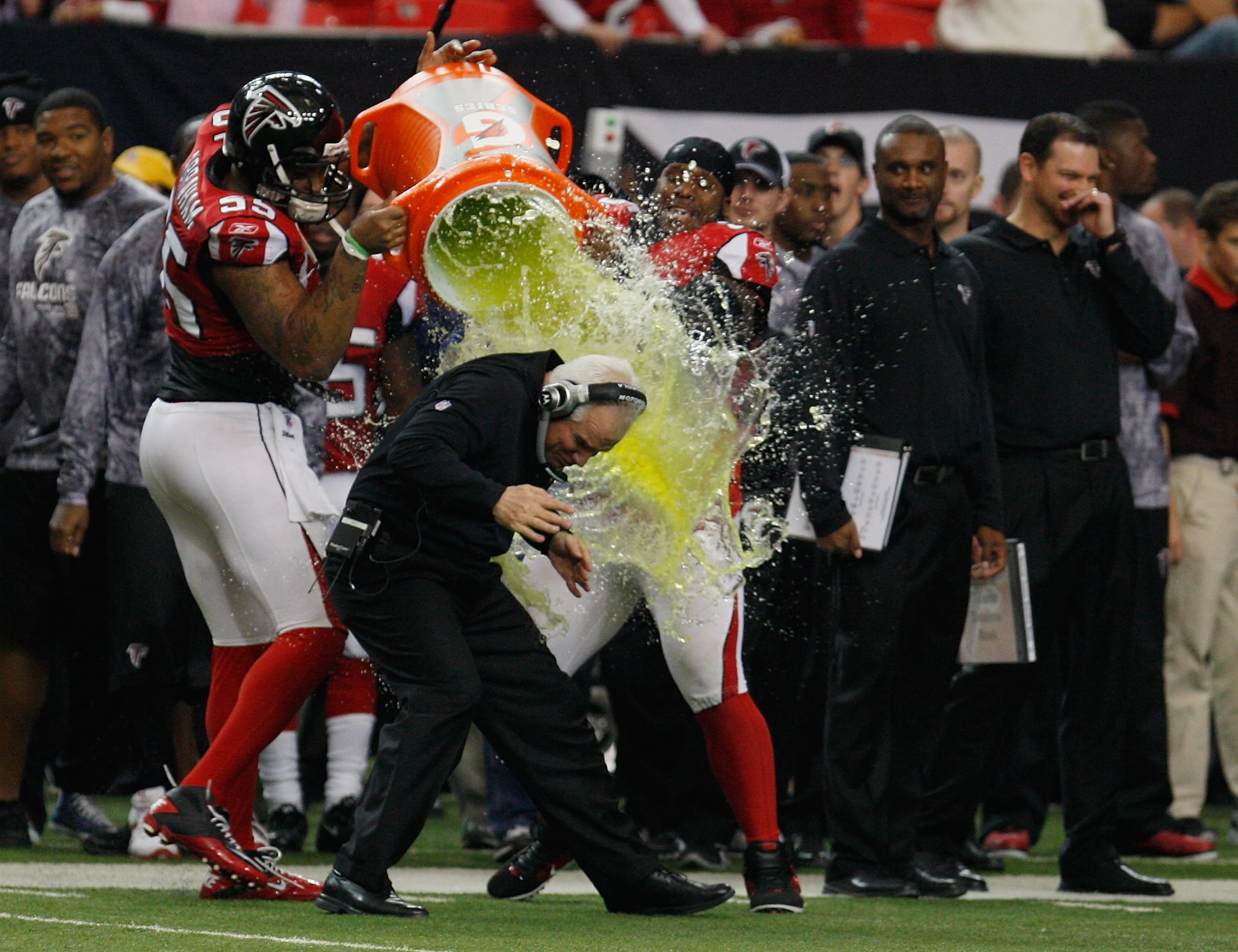 ATLANTA, GA - JANUARY 02: Atlanta Falcons head coach Mike Smith is showered with Gatorade by players John Abraham #55 and Jonathan Babineaux #95 on the sideline during the game against the Carolina Panthers at the Georgia Dome on January 2, 2011 in Atlan ATLANTA, GA - JANUARY 02: Atlanta Falcons head coach Mike Smith is showered with Gatorade by players John Abraham #55 and Jonathan Babineaux #95 on the sideline during the game against the Carolina Panthers at the Georgia Dome on January 2, 2011 in Atlan