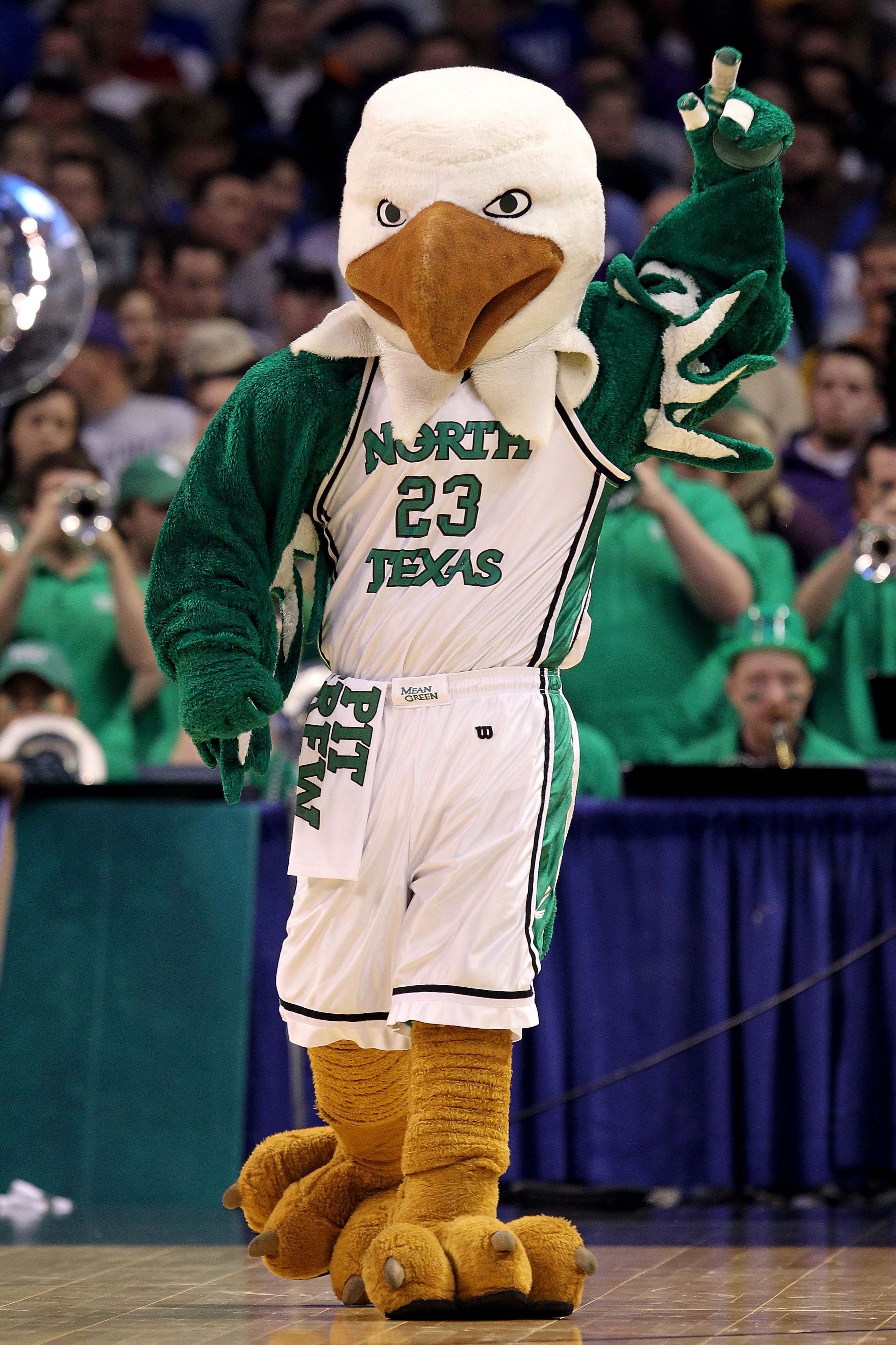 OKLAHOMA CITY - MARCH 18: Scrappy the mascot for the North Texas Mean Green performs against the Kansas State Wildcats during the first round of the 2010 NCAA men's basketball tournament at Ford Center on March 18, 2010 in Oklahoma City, Oklahoma. (Phot OKLAHOMA CITY - MARCH 18: Scrappy the mascot for the North Texas Mean Green performs against the Kansas State Wildcats during the first round of the 2010 NCAA men's basketball tournament at Ford Center on March 18, 2010 in Oklahoma City, Oklahoma. (Phot