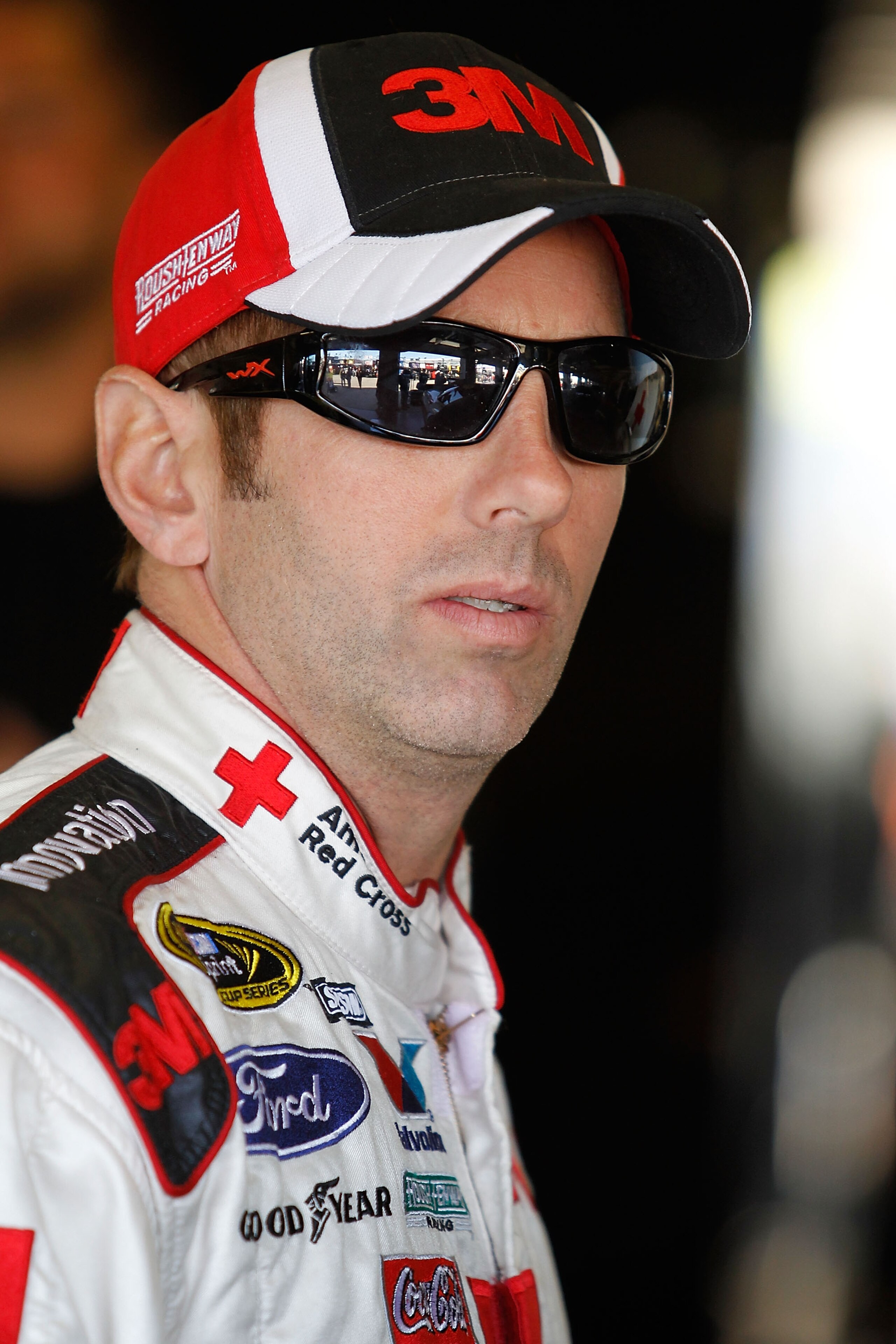 FORT WORTH, TX - NOVEMBER 06:  Greg Biffle, driver of the #16 American Red Cross Ford, stands in the garage area during practice for the NASCAR Sprint Cup Series AAA Texas 500 at Texas Motor Speedway on November 6, 2010 in Fort Worth, Texas.  (Photo by To