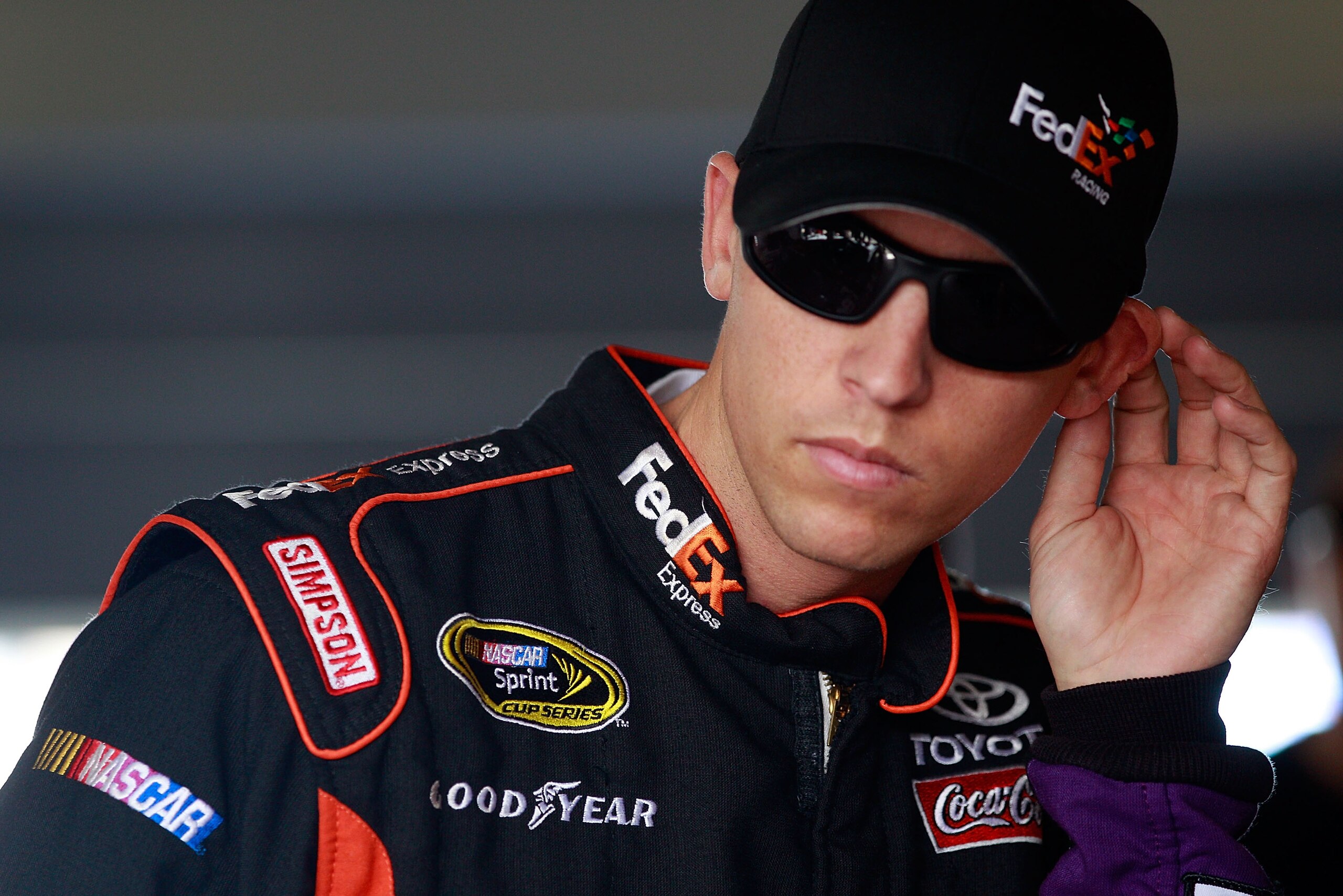HOMESTEAD, FL - NOVEMBER 19:  Denny Hamlin, driver of the #11 FedEx Toyota, stands in the garage during practice for the NASCAR Sprint Cup Series Ford 400 at Homestead-Miami Speedway on November 19, 2010 in Homestead, Florida.  (Photo by Chris Graythen/Ge