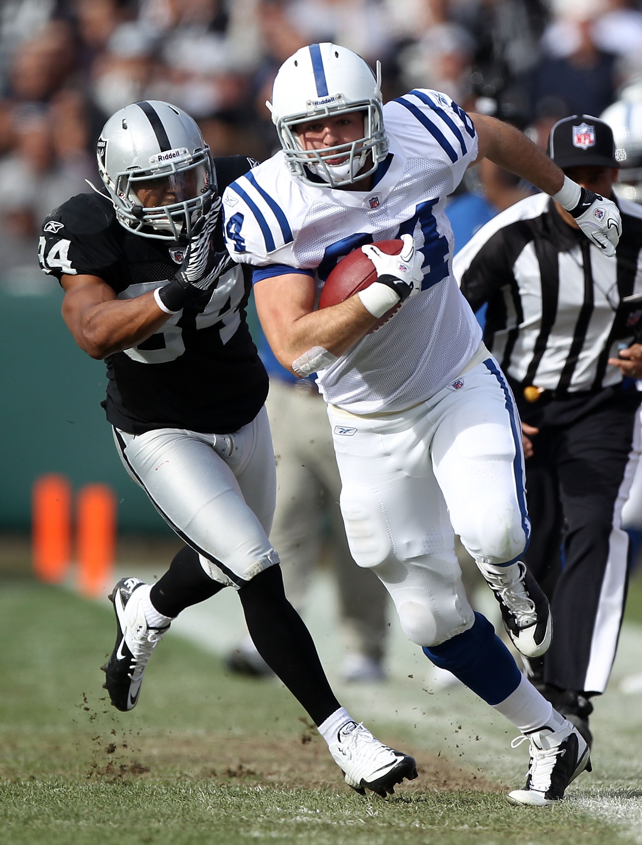 OAKLAND, CA - DECEMBER 26: Jacob Tamme #84 of the Indianapolis Colts runs after a catch past Mike Mitchell #34 of the Oakland Raiders during an NFL game at Oakland-Alameda County Coliseum on December 26, 2010 in Oakland, California. (Photo by Jed Jacob OAKLAND, CA - DECEMBER 26: Jacob Tamme #84 of the Indianapolis Colts runs after a catch past Mike Mitchell #34 of the Oakland Raiders during an NFL game at Oakland-Alameda County Coliseum on December 26, 2010 in Oakland, California. (Photo by Jed Jacob