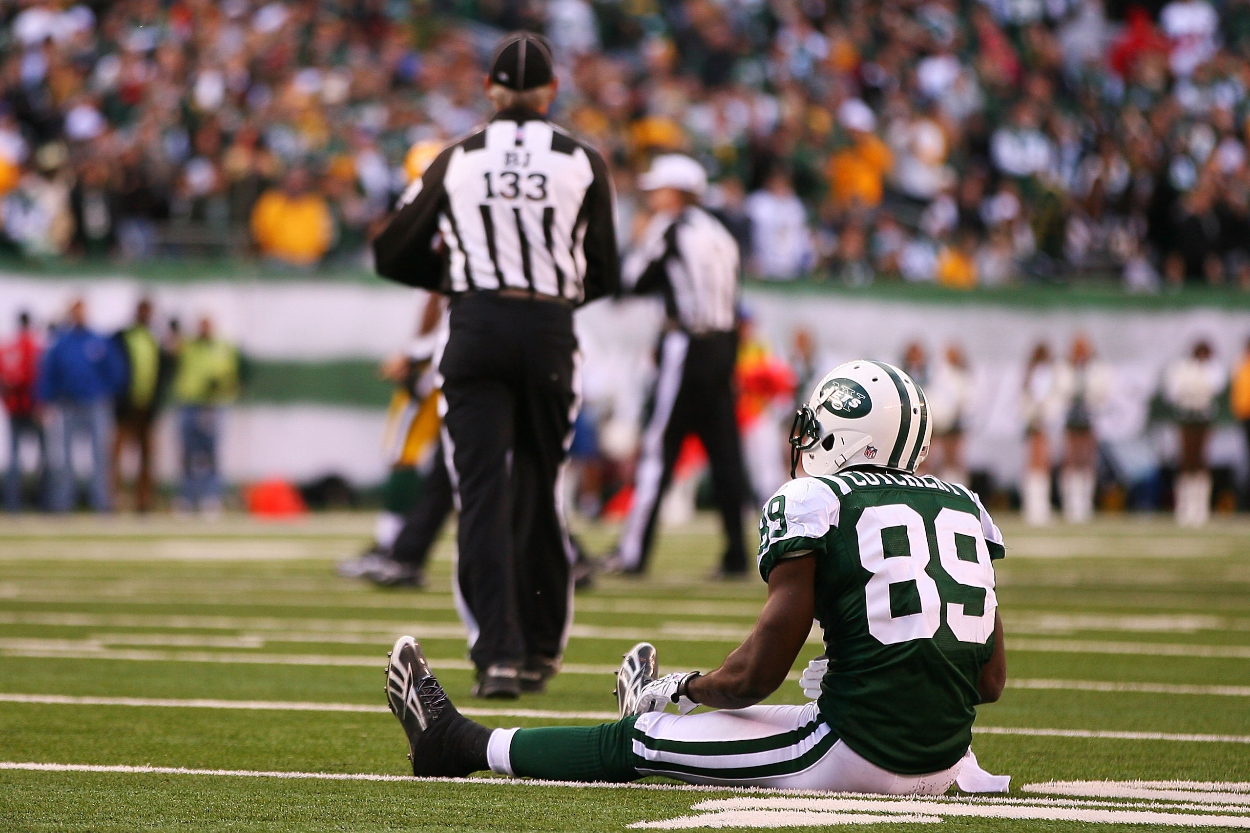 EAST RUTHERFORD, NJ - OCTOBER 31: Jerricho Cotchery #89 of the New York Jets sits on the field after missing a catch in the fourth quarter against the Green Bay Packers on October 31, 2010 at the New Meadowlands Stadium in East Rutherford, New Jersey. Th EAST RUTHERFORD, NJ - OCTOBER 31: Jerricho Cotchery #89 of the New York Jets sits on the field after missing a catch in the fourth quarter against the Green Bay Packers on October 31, 2010 at the New Meadowlands Stadium in East Rutherford, New Jersey. Th