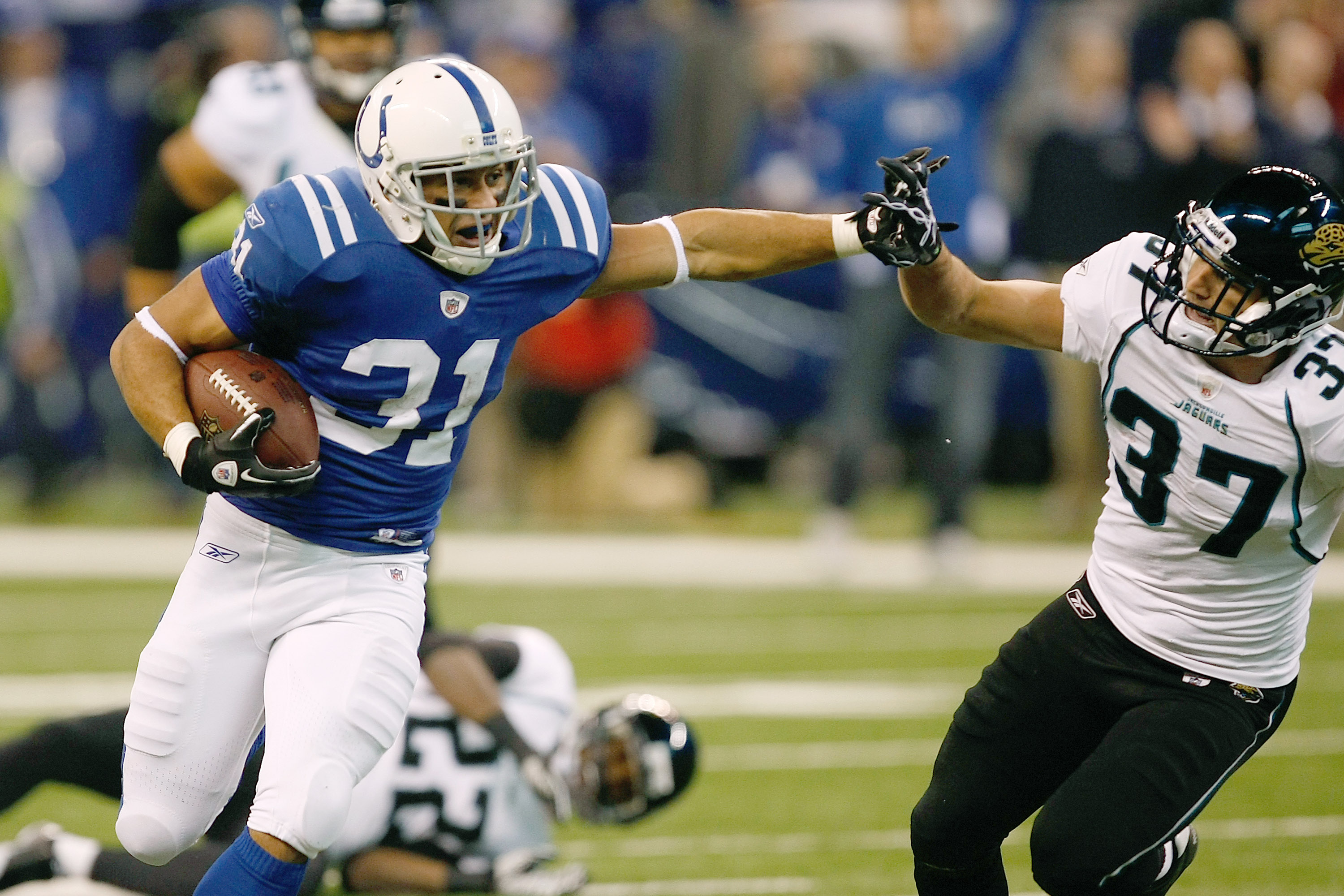 INDIANAPOLIS, IN - DECEMBER 19: Donald Brown #31 of the Indianapolis Colts runs as he is pursued by Tyron Brackenridge #37 of the Jacksonville Jaguars at Lucas Oil Stadium on December 19, 2010 in Indianapolis, Indiana.   The Colts defeated the Jaguars 34-