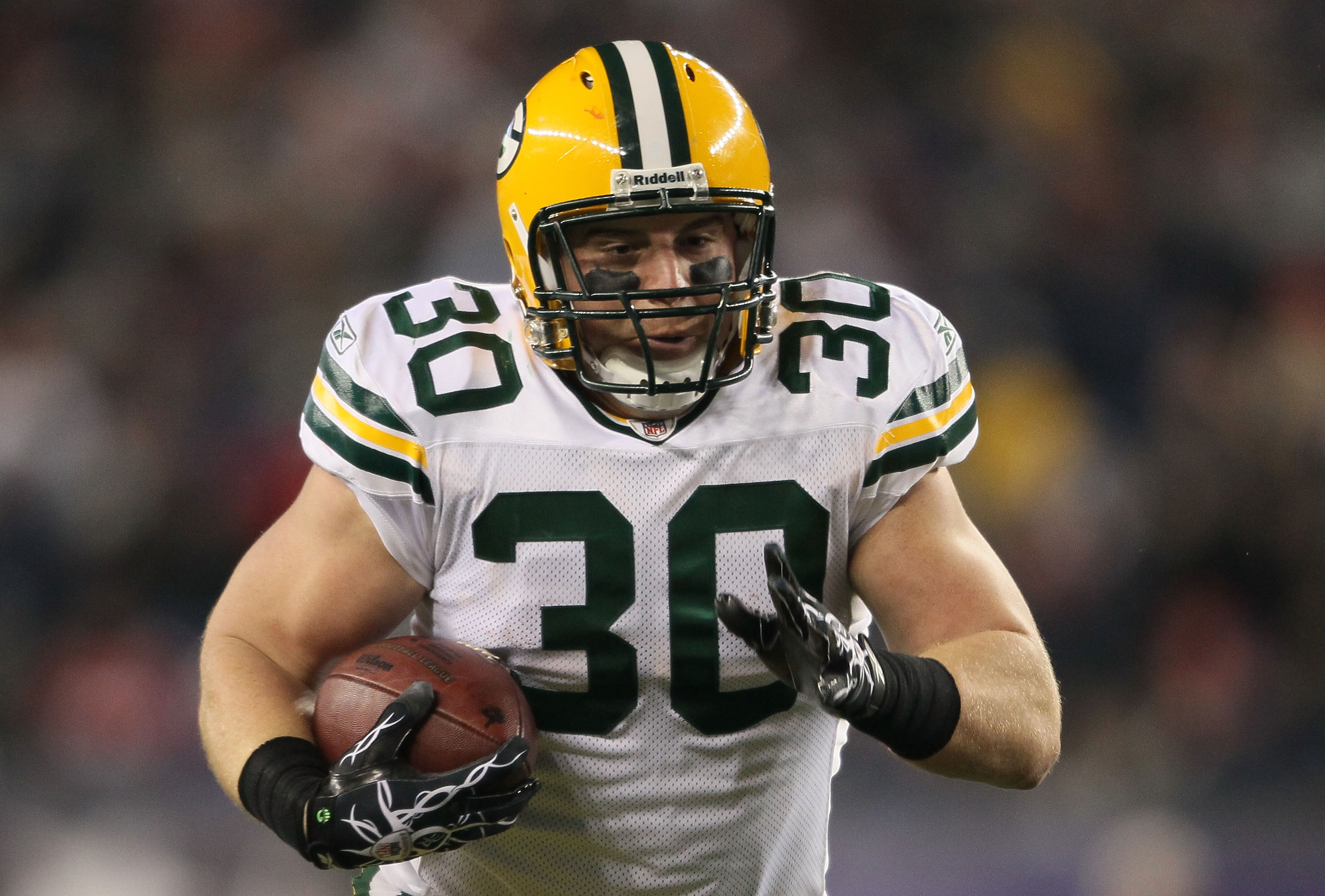 FOXBORO, MA - DECEMBER 19:  Running back John Kuhn #30 of the Green Bay Packers runs the ball during the game against the New England Patriots at Gillette Stadium on December 19, 2010 in Foxboro, Massachusetts.  The Patriots won the game 31-27. (Photo by