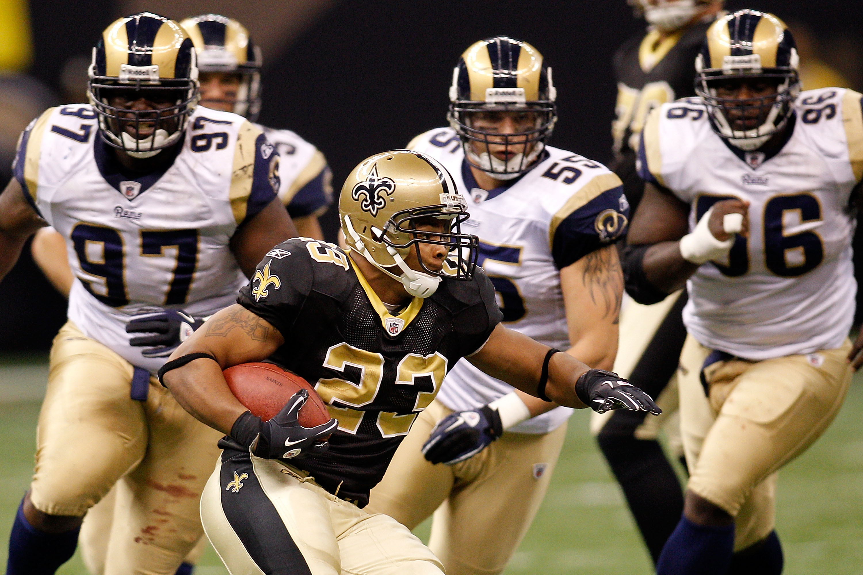 NEW ORLEANS, LA - DECEMBER 12: Pierre Thomas #23 of the New Orleans Saints runs past the defense of the St. Louis Rams at the Louisiana Superdome on December 12, 2010 in New Orleans, Louisiana. The Saints defeated the Rams 31-13. (Photo by Chris Graythe
