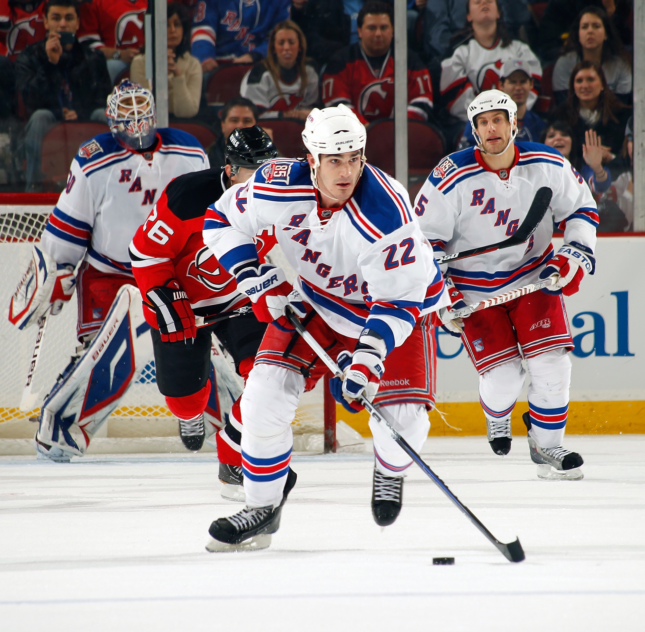 NEWARK, NJ - DECEMBER 29:  Brian Boyle #22 of the New York Rangers skates with the puck against New Jersey Devils during a game on December 29, 2010 at the Prudential Center in Newark, New Jersey. The Rangers won 3-1.  (Photo by Lou Capozzola/Getty Images
