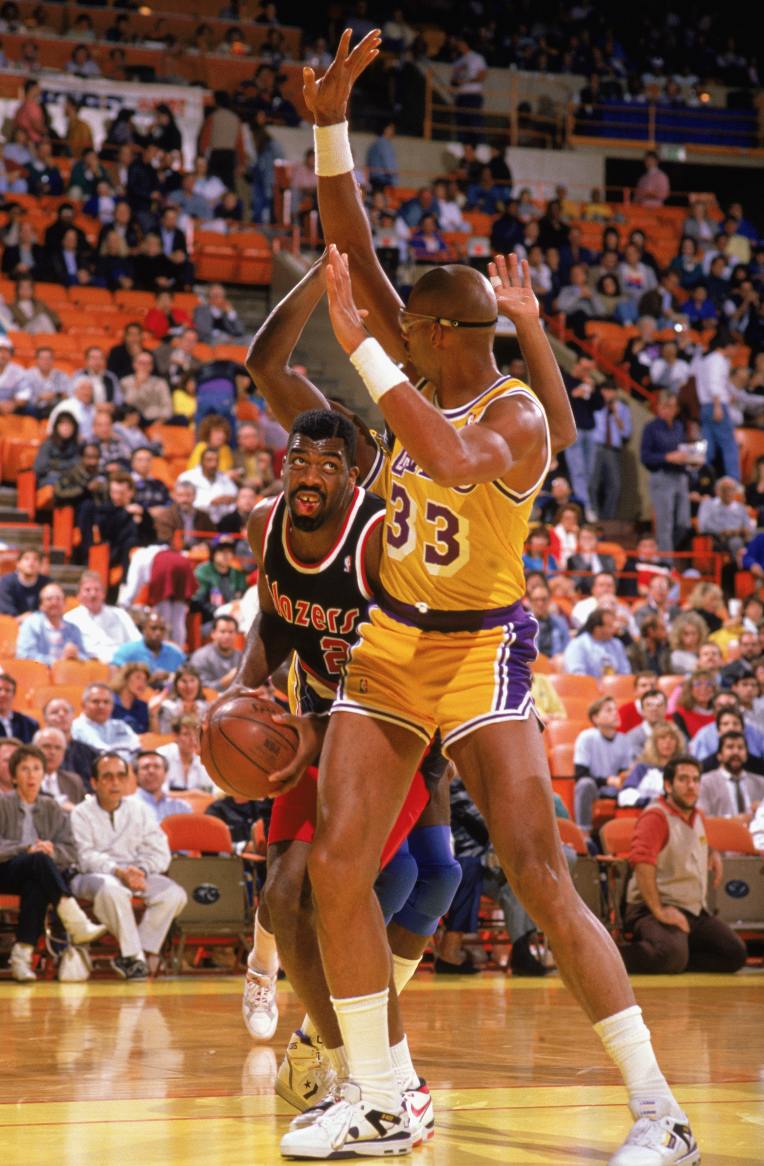 LOS ANGELES - 1988:  Mark Bryant #2 of the Portland Trail Blazers drives around Kareem Abdul-Jabbar #33 of the Los Angeles Lakers during the 1988-1989 NBA season game at the Great Western Forum in Los Angeles, California.  (Photo by: Tim Defrisco/Getty Im
