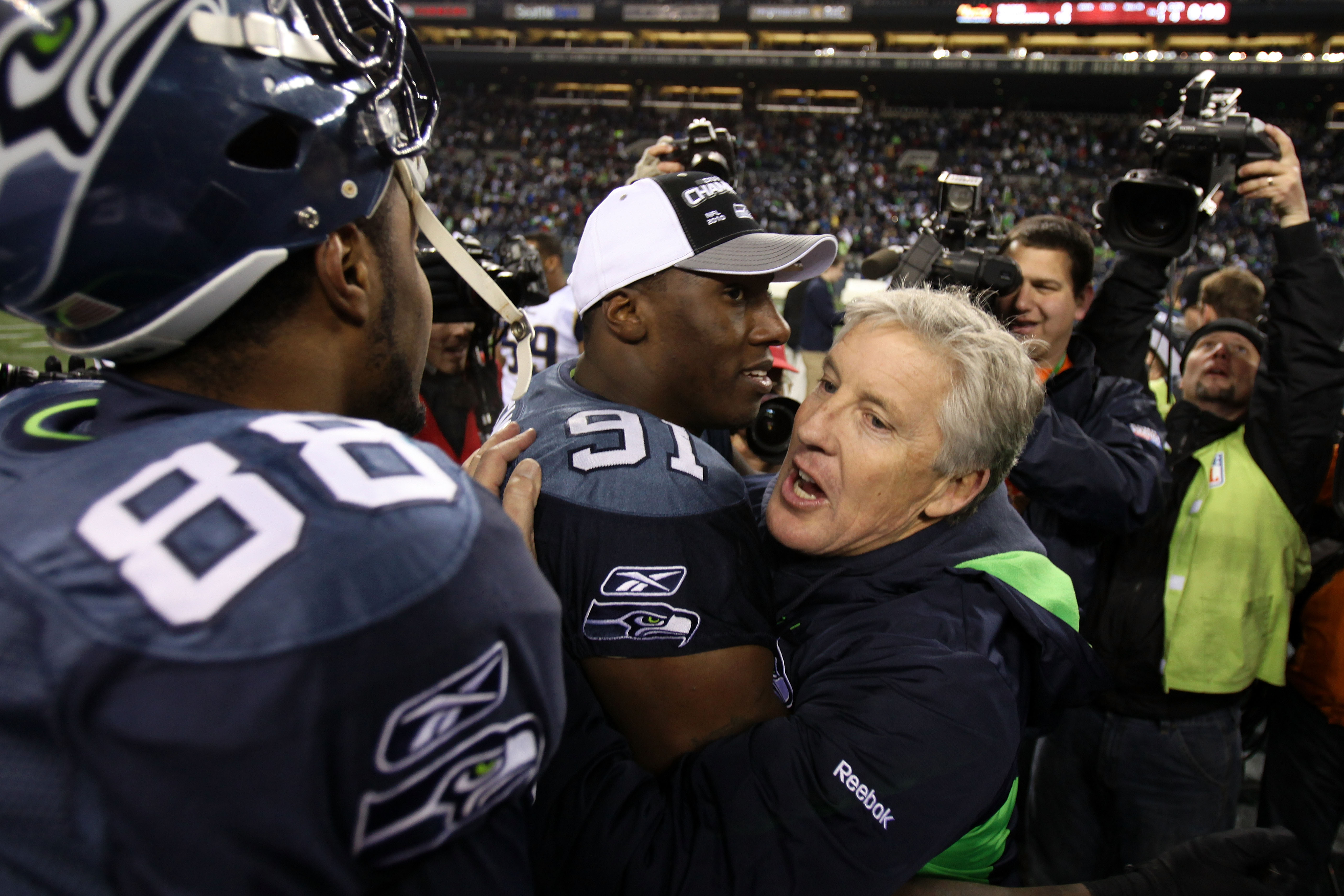 SEATTLE, WA - JANUARY 02:  Head coach Pete Carroll of the Seattle Seahawks hugs defensive end Chris Clemons #91 after defeating the St. Louis Rams 16-6 at Qwest Field on January 2, 2011 in Seattle, Washington.  (Photo by Otto Greule Jr/Getty Images)