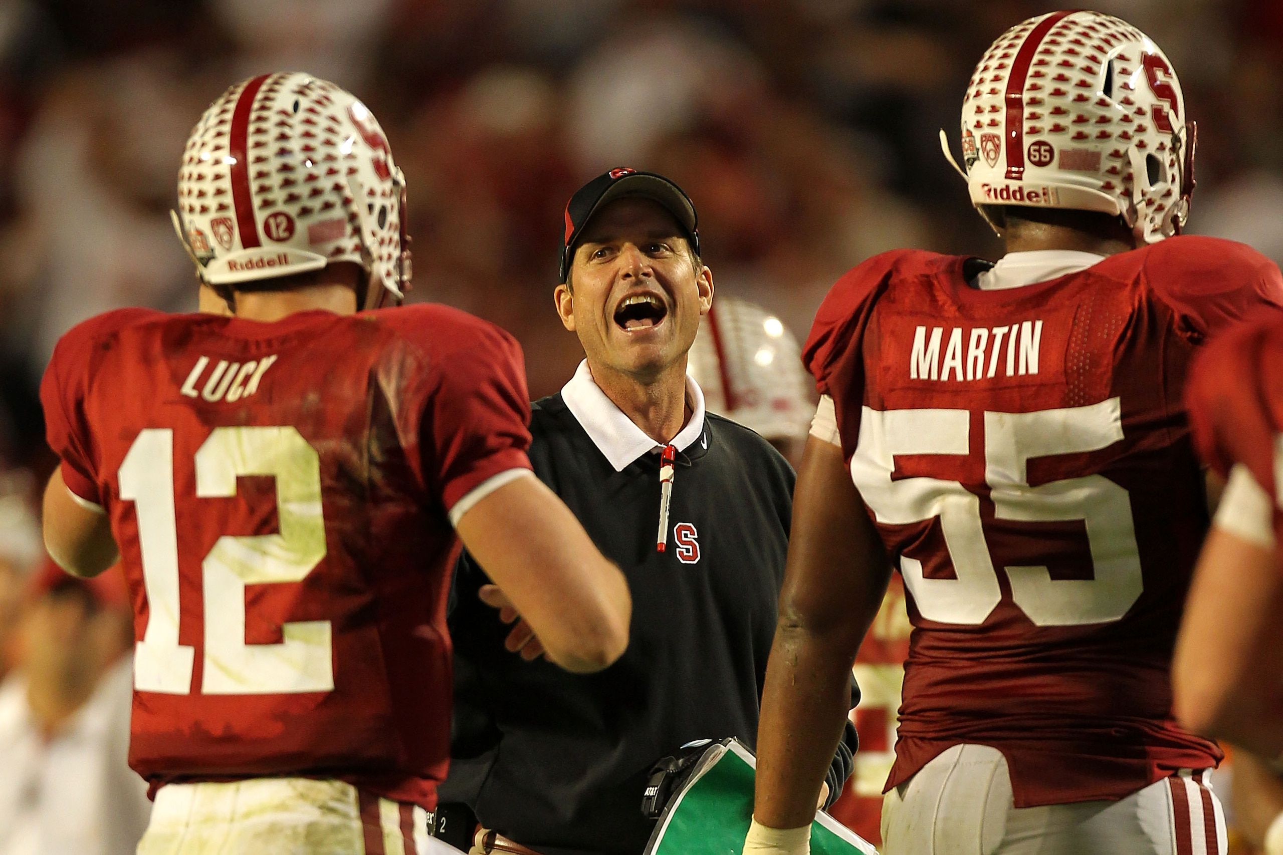 MIAMI, FL - JANUARY 03:  Head coach Jim Harbaugh of the Stanford Cardinal celebrates a play with Andrew Luck #12 against the Virginai Tech Hokies during the 2011 Discover Orange Bowl at Sun Life Stadium on January 3, 2011 in Miami, Florida. Stanford won 4