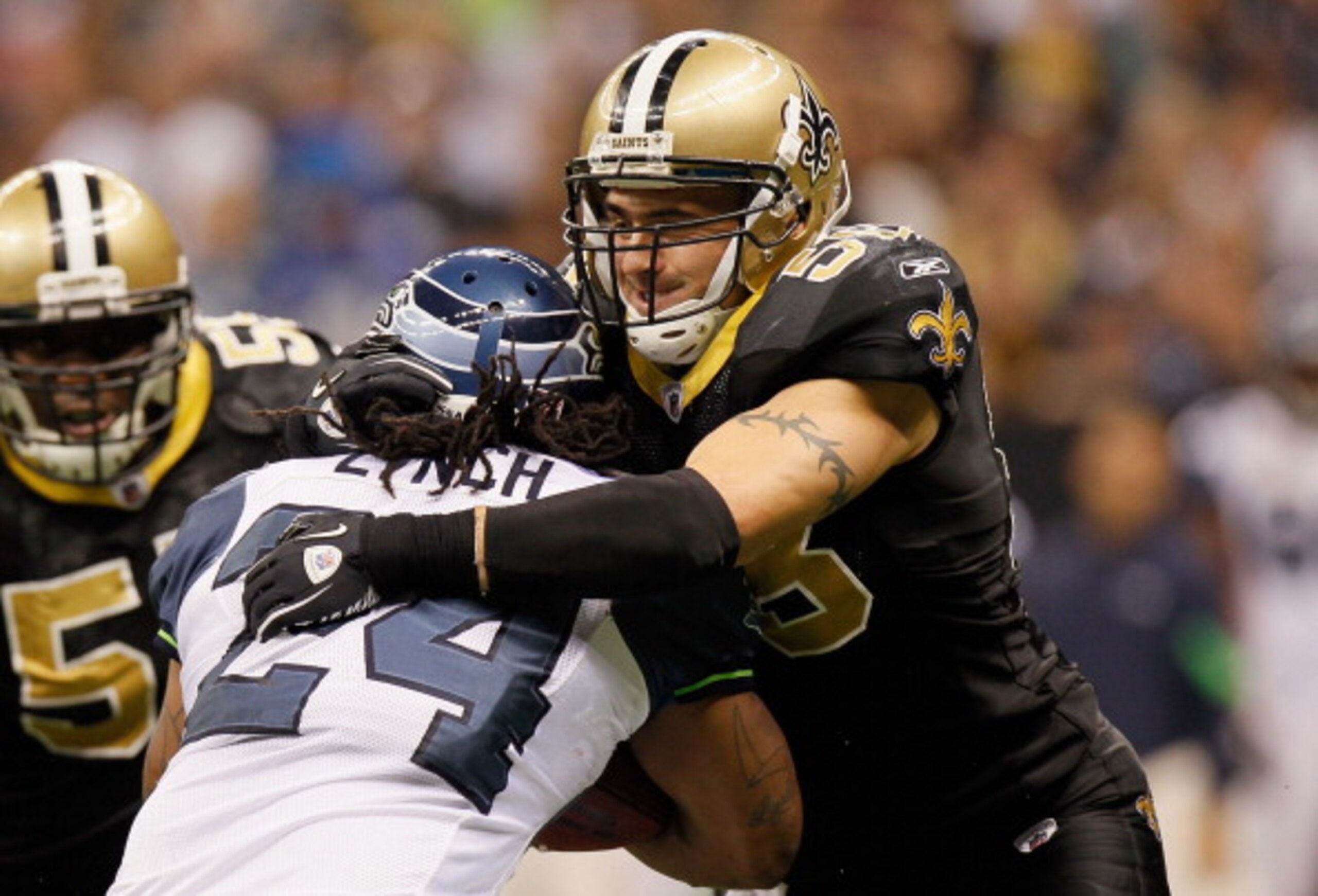 NEW ORLEANS - NOVEMBER 21:  Scott Shanle #58 of the New Orleans Saints against Marshawn Lynch #24 of the Seattle Seahawks at Louisiana Superdome on November 21, 2010 in New Orleans, Louisiana.  (Photo by Kevin C. Cox/Getty Images)