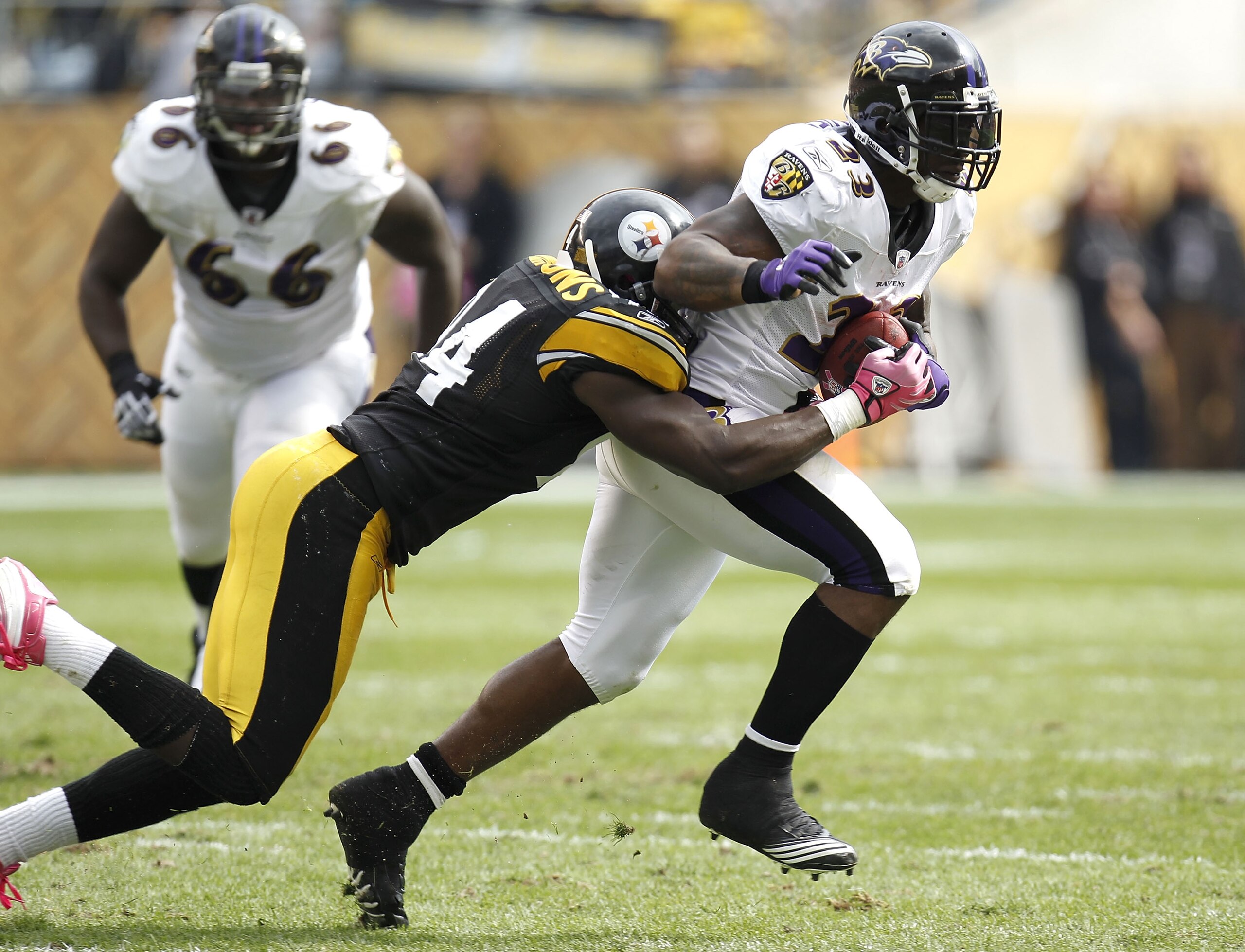 PITTSBURGH - OCTOBER 03:  Willis McGahee #23 of the Baltimore Ravens tries to escape the tackle of Lawrence Timmons #94 of the Pittsburgh Steelers on October 3, 2010 at Heinz Field in Pittsburgh, Pennsylvania. Baltimore won the game 17-14.  (Photo by Greg