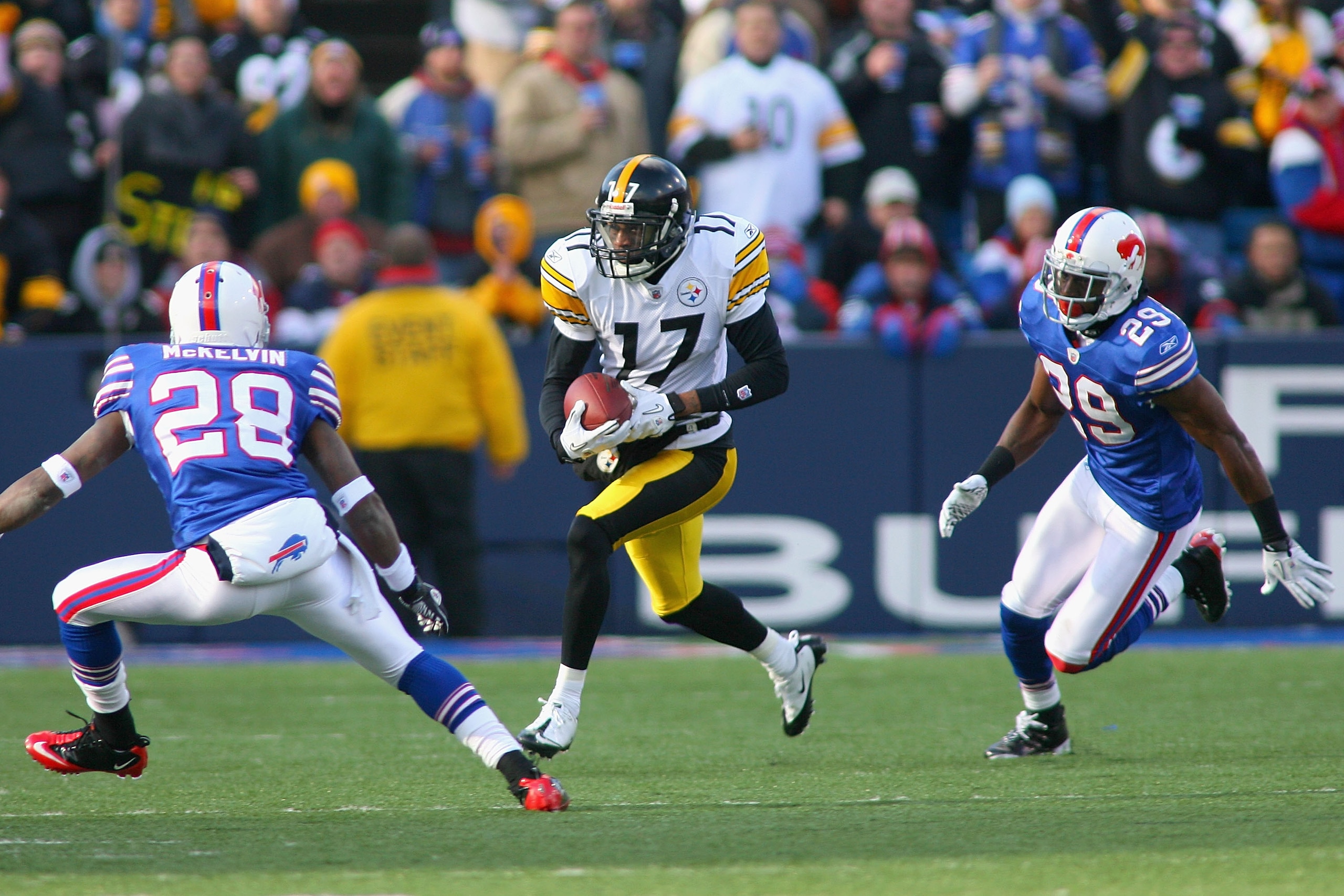 ORCHARD PARK, NY - NOVEMBER 28: Mike Wallace #17 of the Pittsburgh Steelers runs between Leodis McKelvin #28 and Drayton Florence #29 of the Buffalo Bills  at Ralph Wilson Stadium at Ralph Wilson Stadium on November 28, 2010 in Orchard Park, New York. Pit