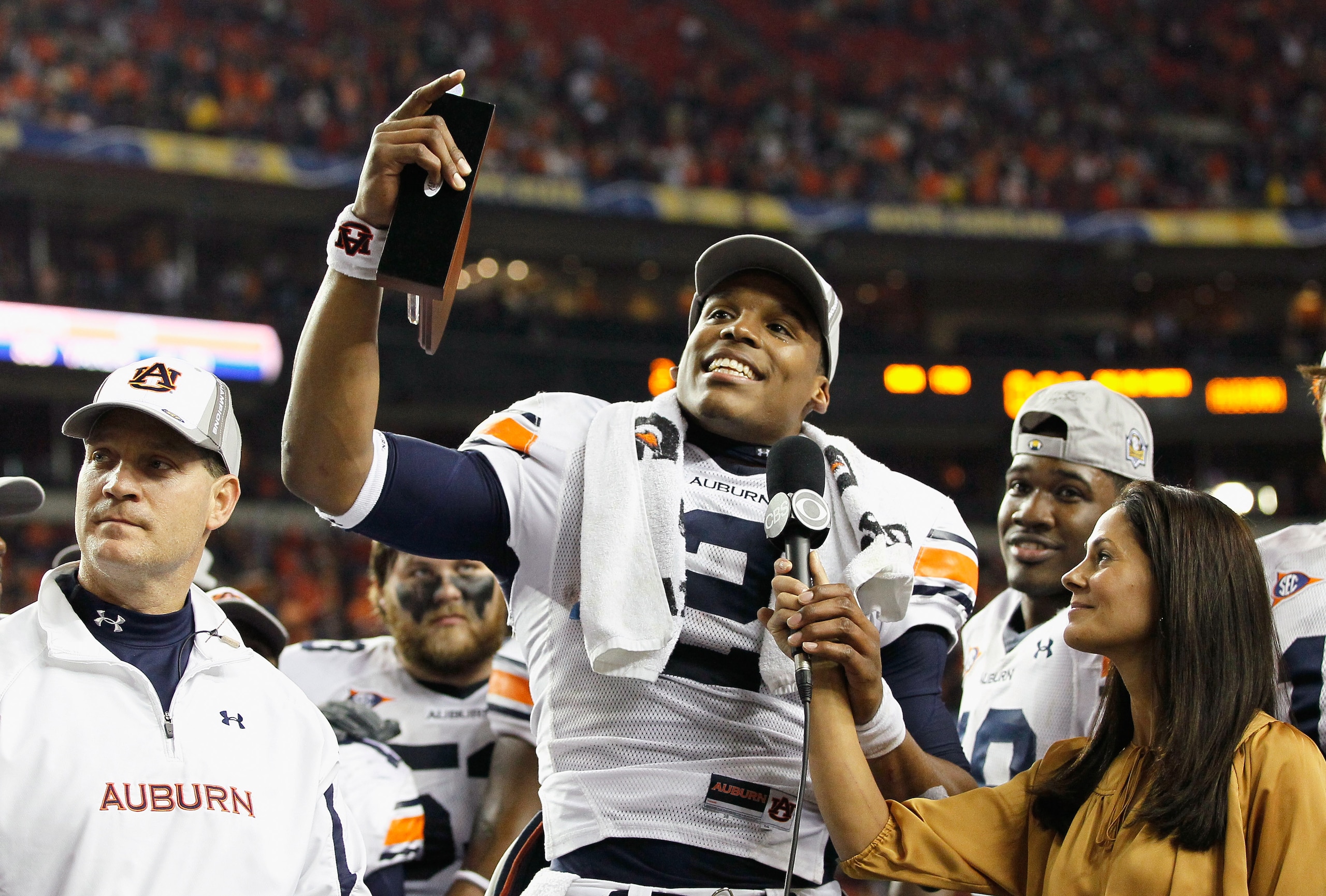 ATLANTA, GA - DECEMBER 04:  Quarterback Cam Newton #2 of the Auburn Tigers talks to CBS sideline reporter Tracy Wolfson after winning the MVP trophy in their 56-17 win over the South Carolina Gamecocks during the 2010 SEC Championship at Georgia Dome on D