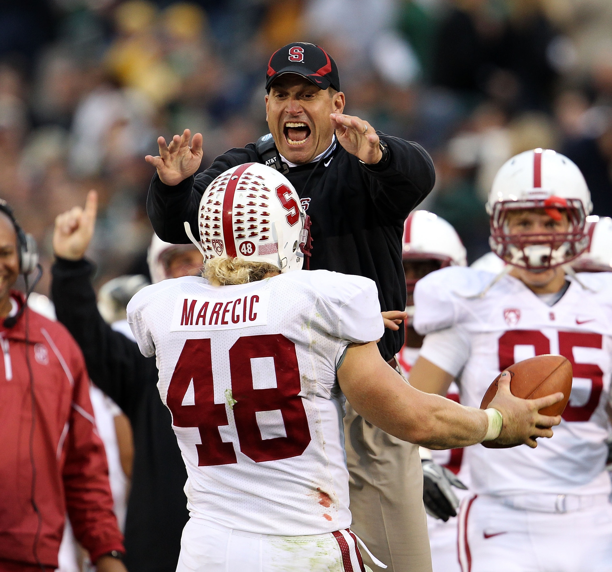 SOUTH BEND, IN - SEPTEMBER 25: Head coach Jim Harbaugh of the Stanford Cardinal jumps to greet Owen Marecic #48 after Marecic intercepted a pass for a touchdown against the Notre Dame Fighting Irish at Notre Dame Stadium on September 25, 2010 in South Ben