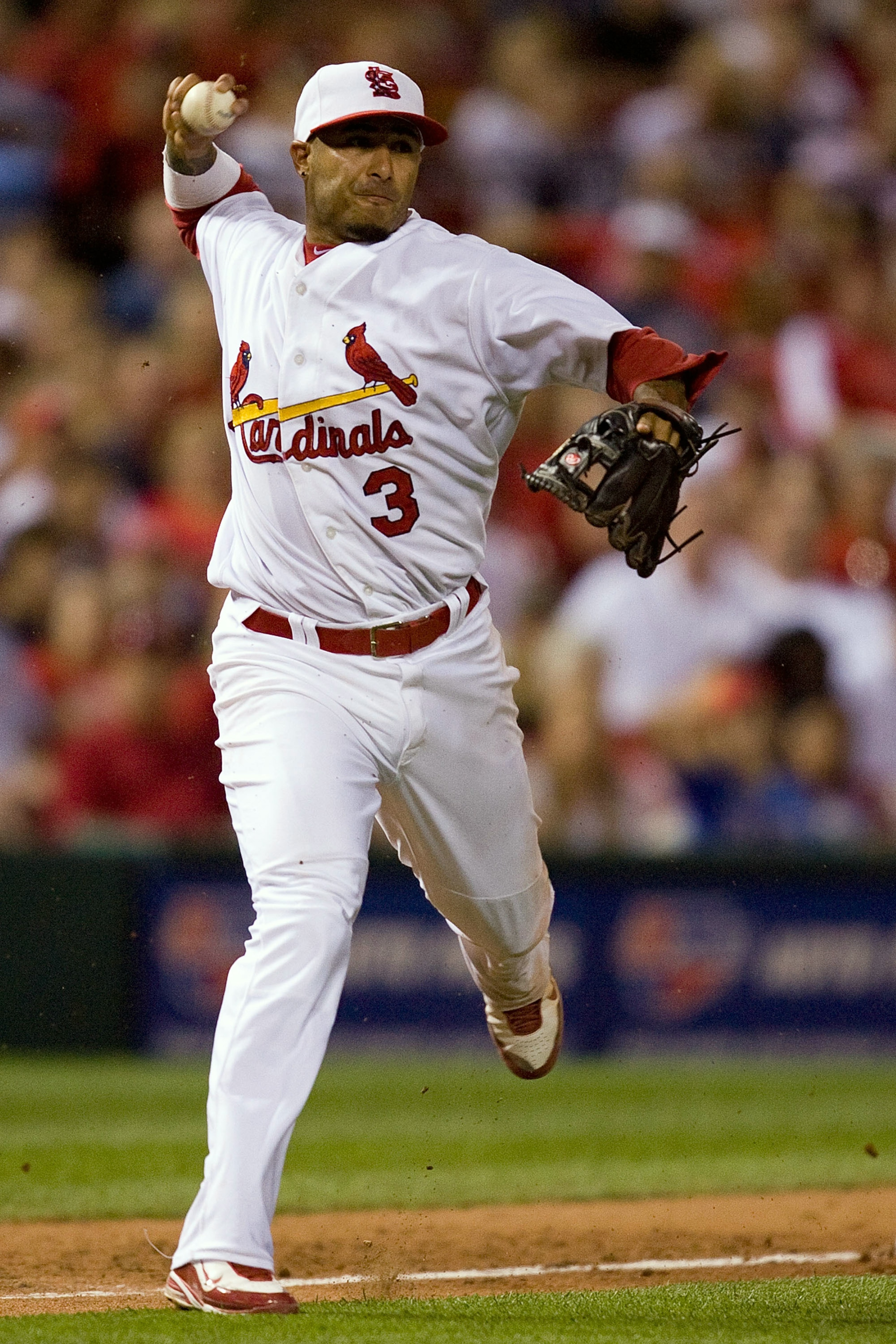 ST. LOUIS - JULY 2: Felipe Lopez #3 of the St. Louis Cardinals throws to first base against the Milwaukee Brewers at Busch Stadium on July 2, 2010 in St. Louis, Missouri.  The Cardinals beat the Brewers 5-0.  (Photo by Dilip Vishwanat/Getty Images)