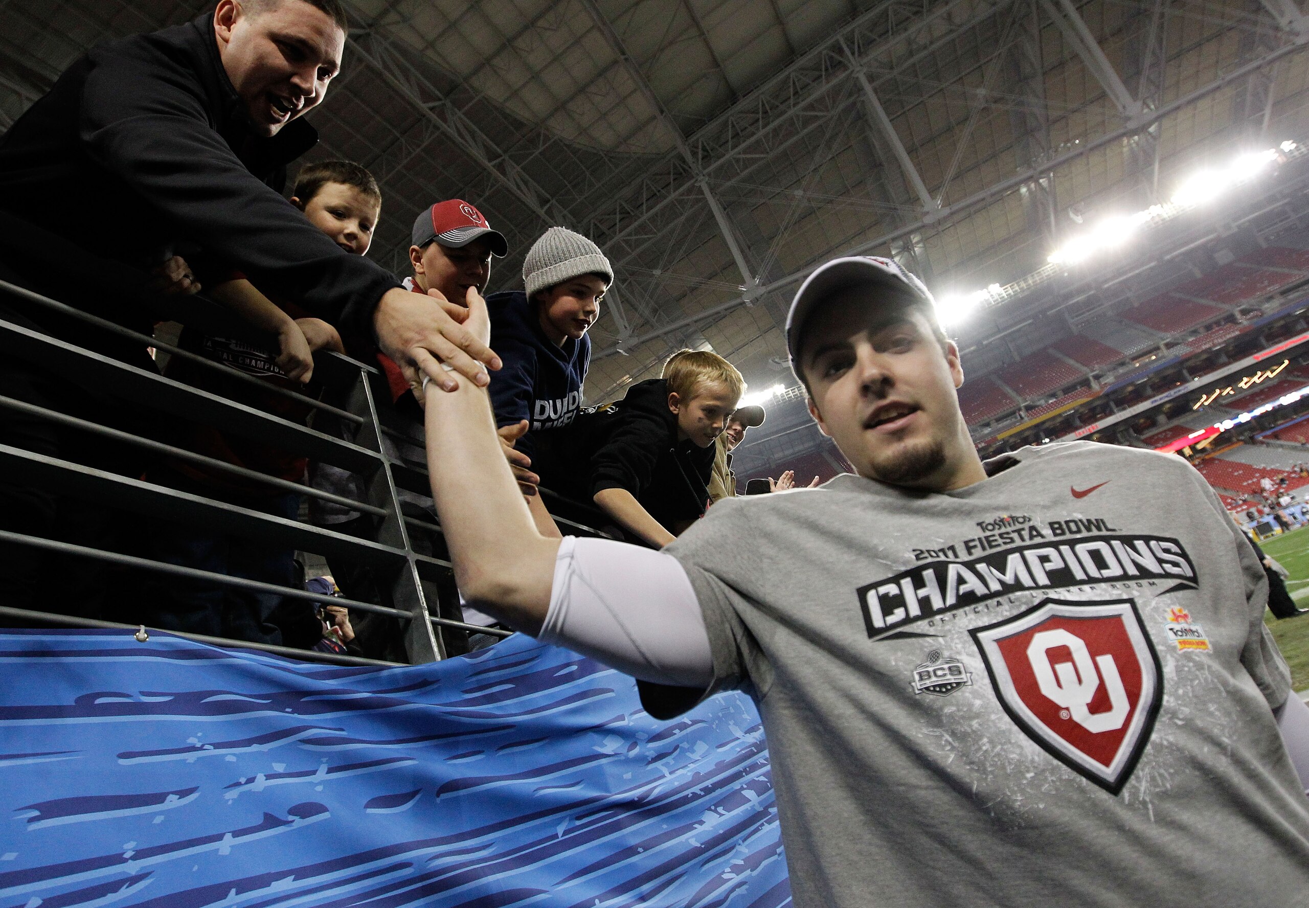 GLENDALE, AZ - JANUARY 01:  Quarterback Landry Jones #12 of the Oklahoma Sooners and offensive MVP celebrates the Sooners 48-20 victory against the Connecticut Huskies during the Tostitos Fiesta Bowl at the Universtity of Phoenix Stadium on January 1, 201