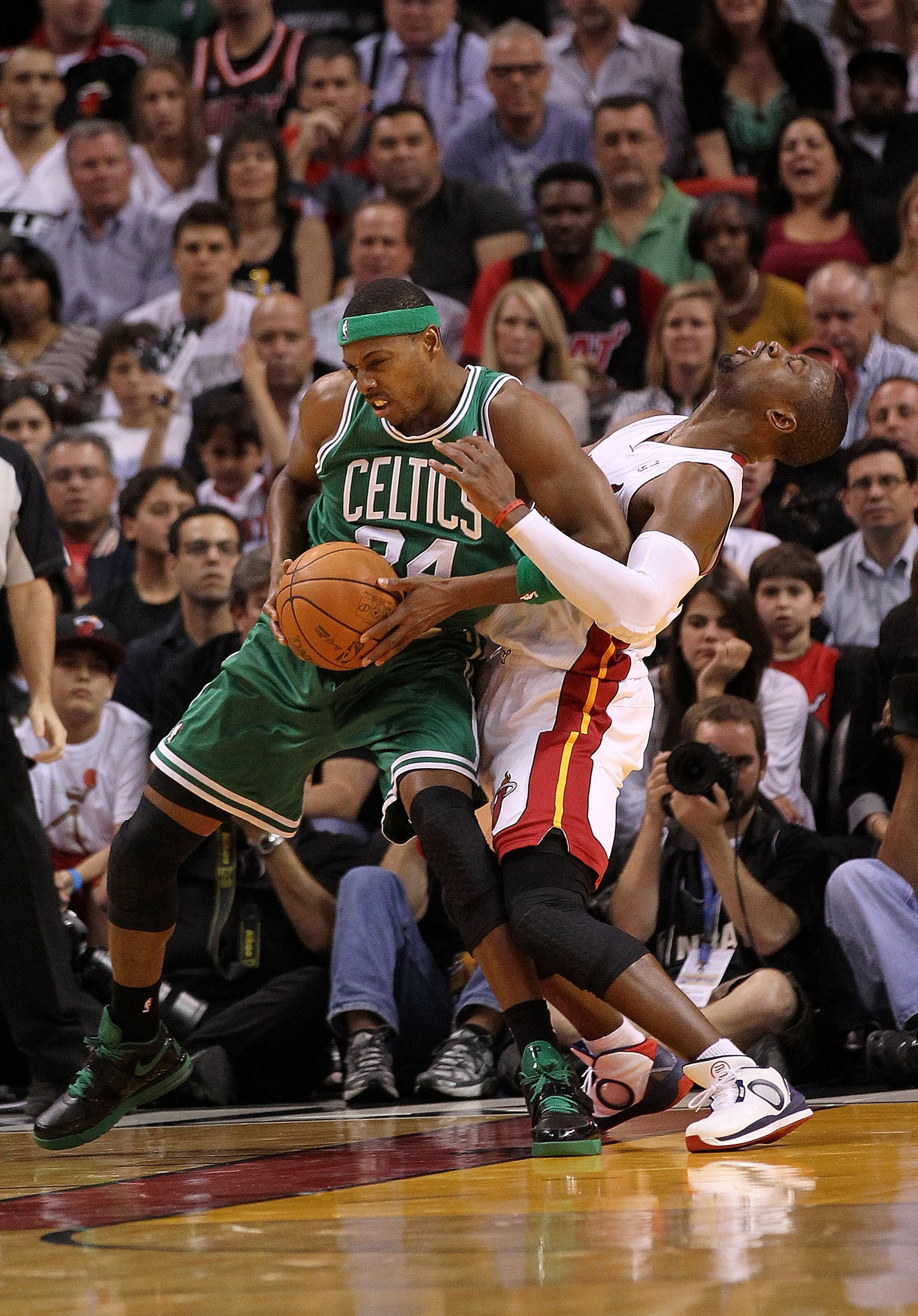 MIAMI - NOVEMBER 11:   Paul Pierce #34 of the Boston Celtics fouls Chris Bosh #1 during a game against the  Miami Heat at American Airlines Arena on November 11, 2010 in Miami, Florida. NOTE TO USER: User expressly acknowledges and agrees that, by downloa