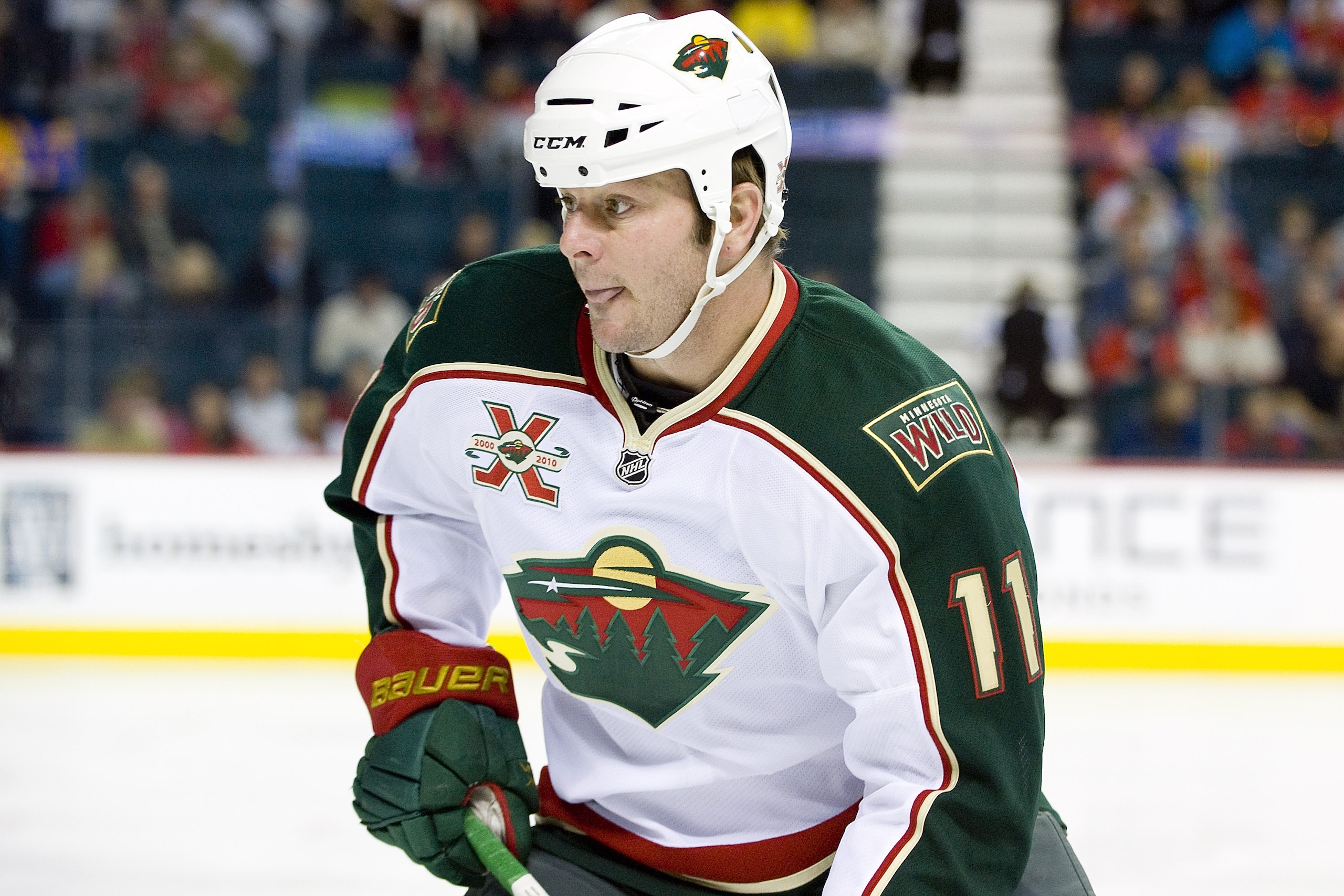 EDMONTON, AB - NOVEMBER 29:  John Madden #11 of the Minnesota Wild concentrates on the puck during a game against the Calgary Flames at Scotiabank Saddledome on November 29, 2010 in Calgary, Alberta, Canada. The Flames beat the Wild 3-0.  (Photo by Dylan