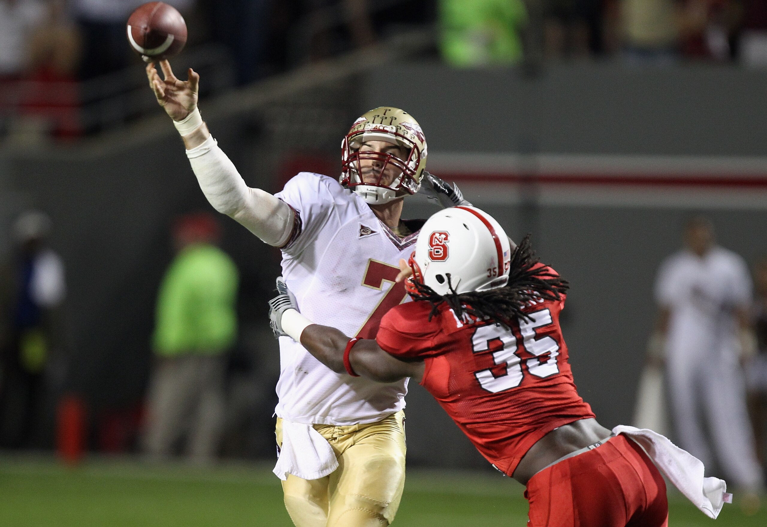 RALEIGH, NC - OCTOBER 28:  Christian Ponder #7 of the Florida State Seminoles drops back to throw a pass in pressure with Terrell Manning #35 of the North Carolina State Wolfpack giving chase during their game at Carter-Finley Stadium on October 28, 2010