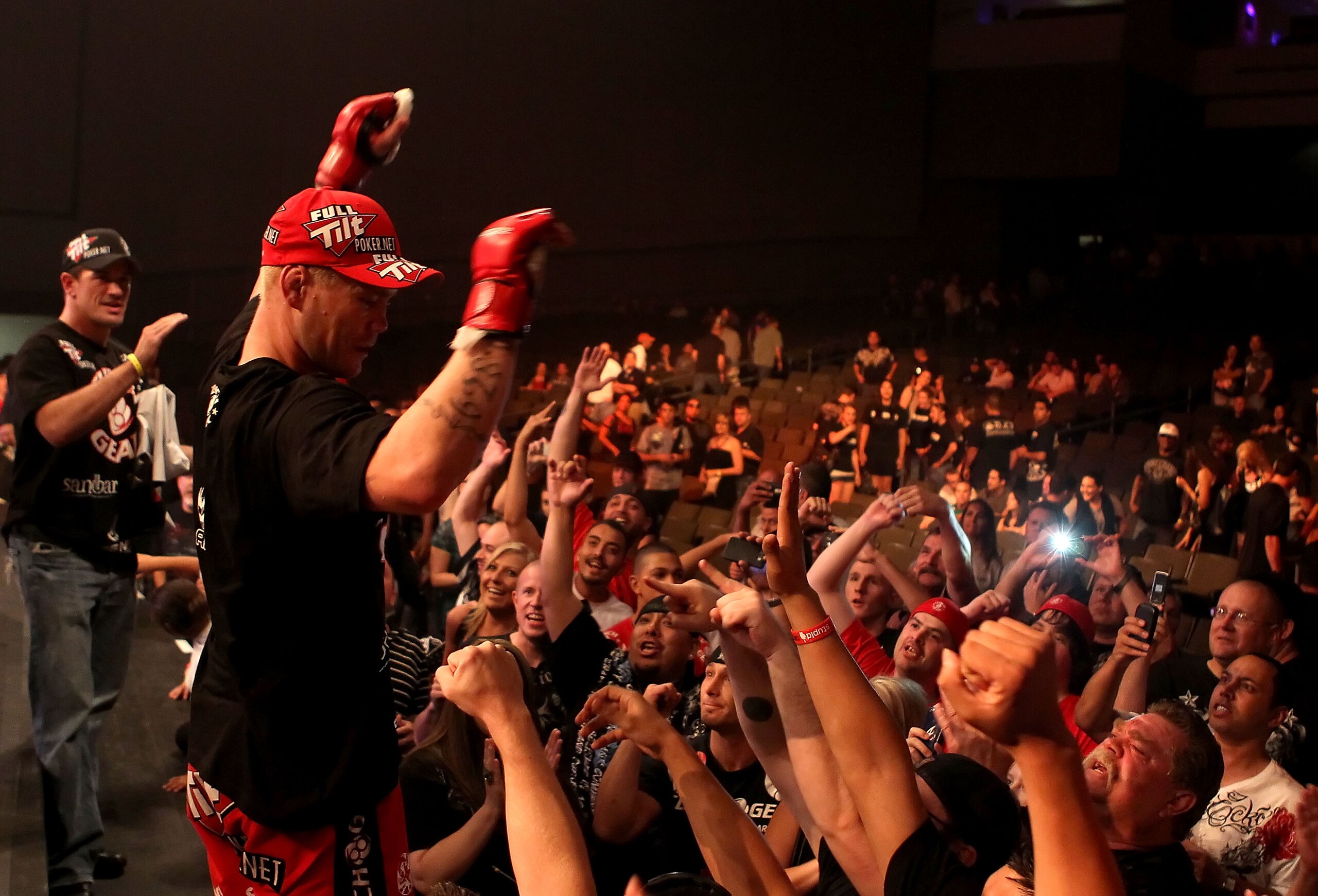 PHOENIX - AUGUST 13:  Joe Riggs celebrates with fans after defeating Louis Taylor (not pictured) in the Strikeforce Challengers Men's Main card bout at Dodge Theater on August 13, 2010 in Phoenix, Arizona.  (Photo by Christian Petersen/Getty Images)