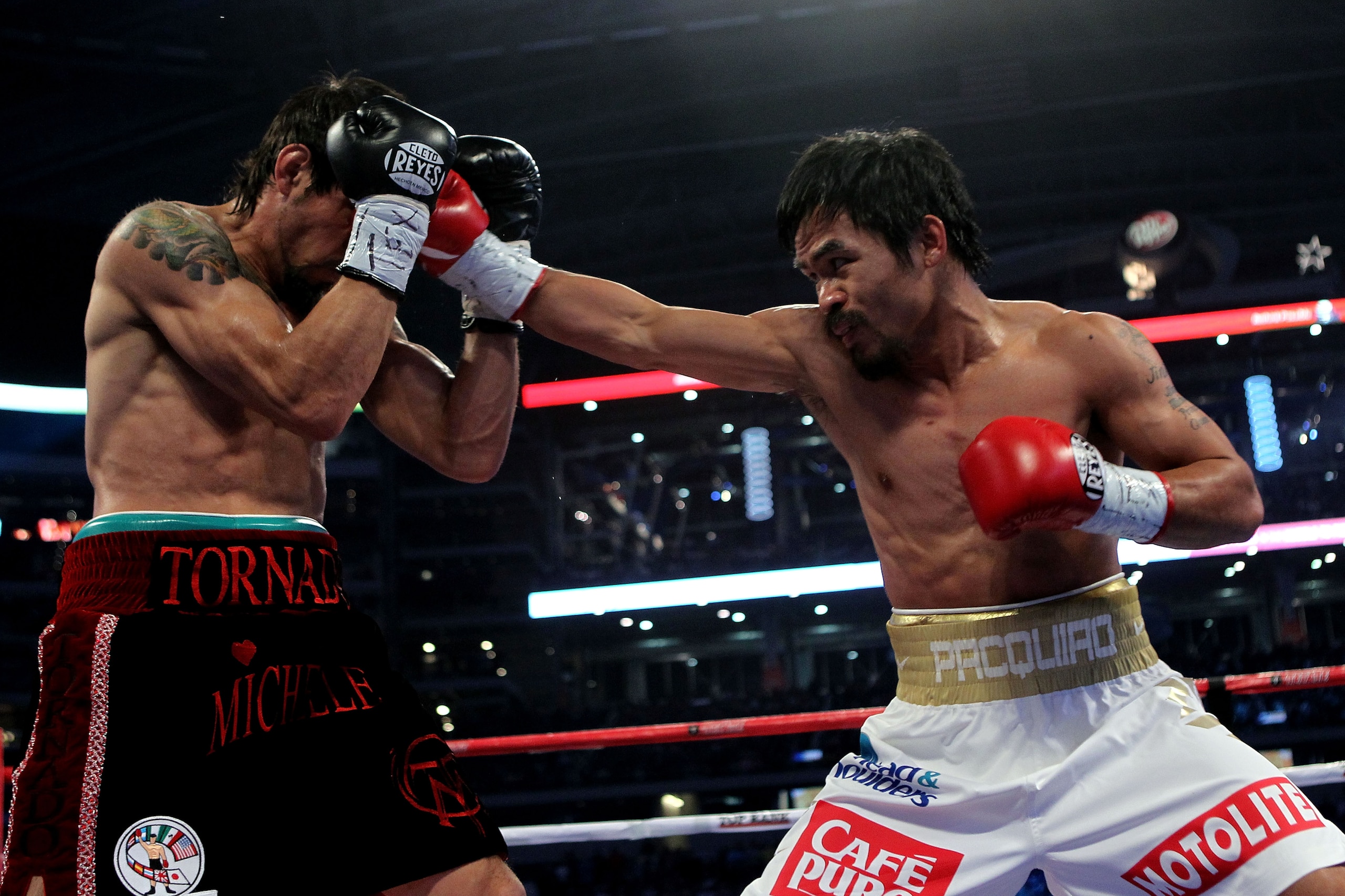 ARLINGTON, TX - NOVEMBER 13: Manny Pacquiao (white trunks) of the Philippines lands a punch against Antonio Margarito (black trunks) of Mexico during their WBC World Super Welterweight Title bout at Cowboys Stadium on November 13, 2010 in Arlington, Texa ARLINGTON, TX - NOVEMBER 13: Manny Pacquiao (white trunks) of the Philippines lands a punch against Antonio Margarito (black trunks) of Mexico during their WBC World Super Welterweight Title bout at Cowboys Stadium on November 13, 2010 in Arlington, Texa