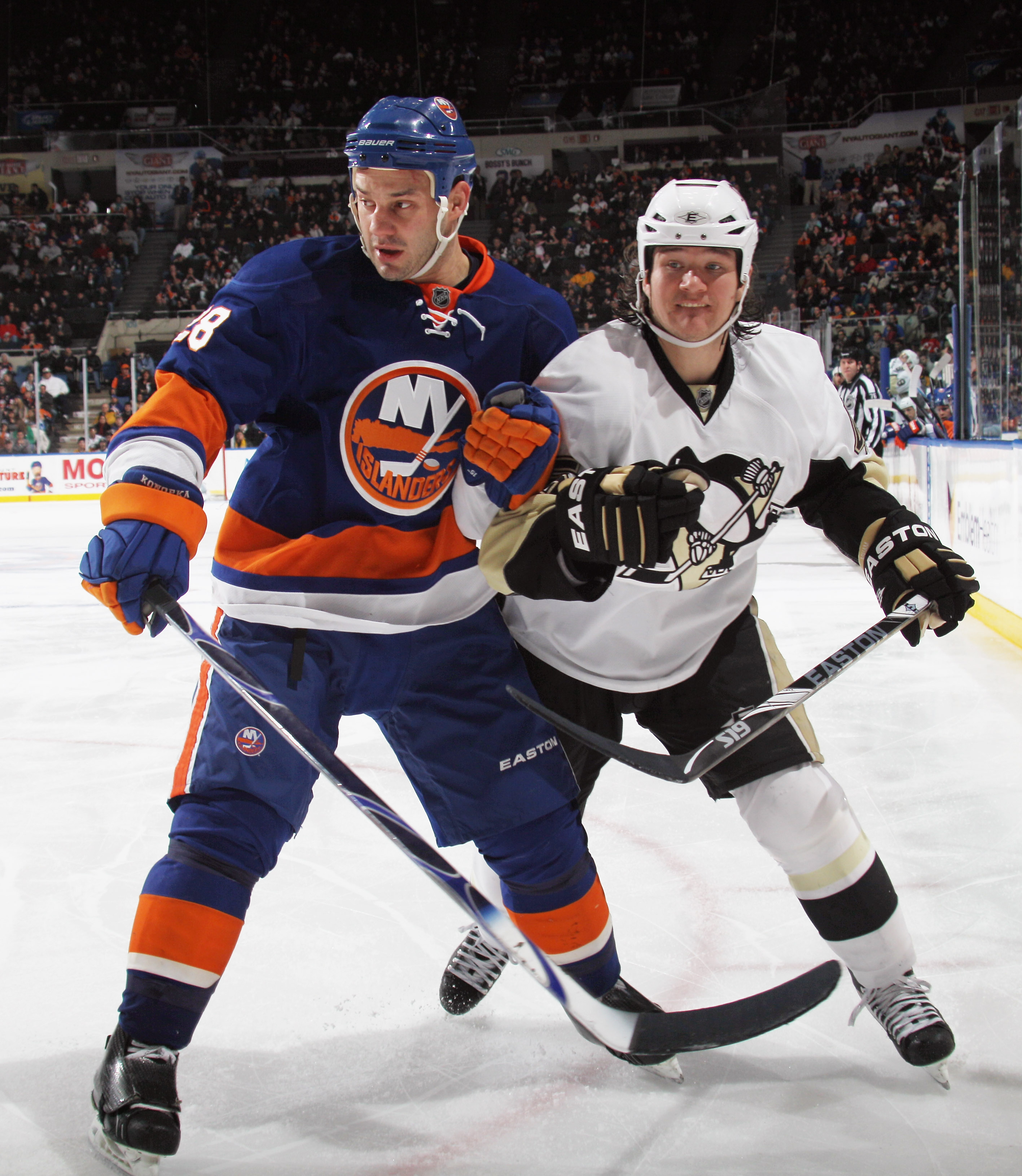 UNIONDALE, NY - DECEMBER 29:  Arron Asham #45 of the Pittsburgh Penguins skates against Zenon Konopka #28 of the New York Islanders at the Nassau Coliseum on December 29, 2010 in Uniondale, New York. The Islanders defeated the Penguins 2-1 in the shootout