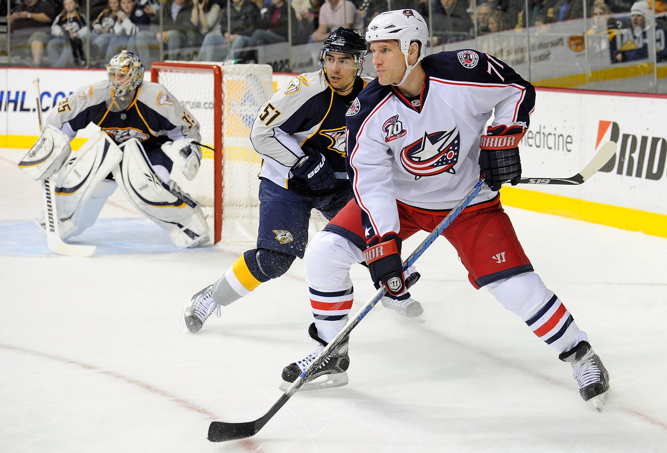 NASHVILLE, TN - JANUARY 02:  Francis Bouillon #51 of the Nashville Predators tries to get position on Chris Clark #71 of the Columbus Blue Jackets on January 2, 2011 at the Bridgestone Arena in Nashville, Tennessee.  (Photo by Frederick Breedon/Getty Imag