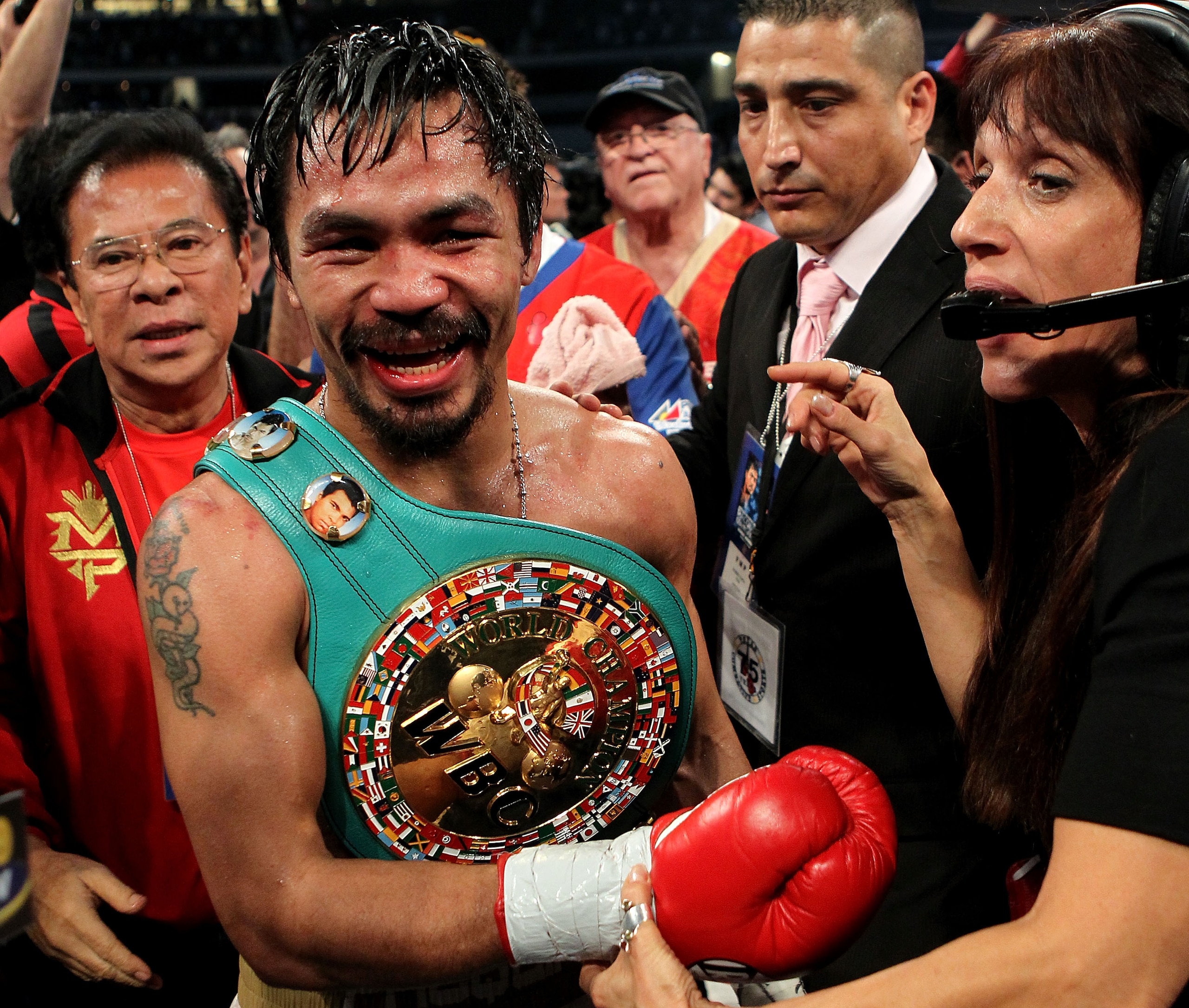 ARLINGTON, TX - NOVEMBER 13: Manny Pacquiao (white trunks) of the Philippines celebrates after he was declared the winner by a unanimous decision against Antonio Margarito (black trunks) of Mexico during their WBC World Super Welterweight Title bout at C ARLINGTON, TX - NOVEMBER 13: Manny Pacquiao (white trunks) of the Philippines celebrates after he was declared the winner by a unanimous decision against Antonio Margarito (black trunks) of Mexico during their WBC World Super Welterweight Title bout at C