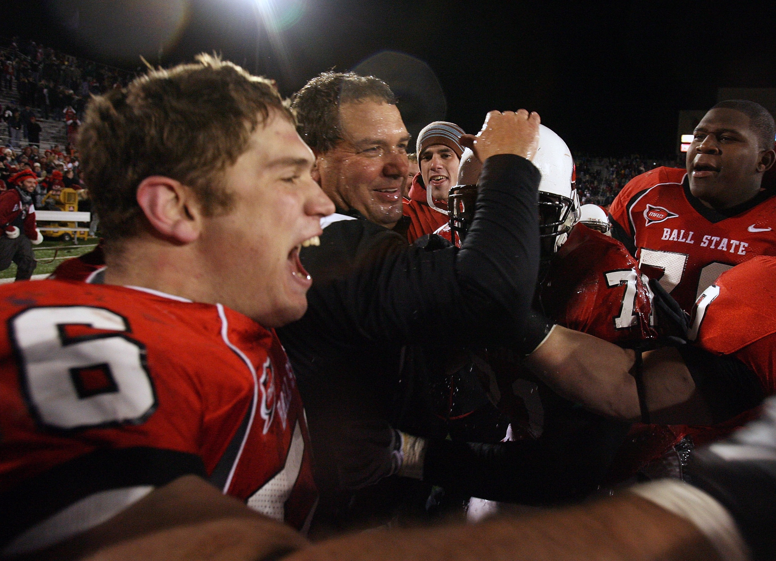 MUNCIE, IN - NOVEMBER 25:  Head coach Brady Hoke of the Ball State Cardinals is hugged by players following the Mid-American Conference (MAC) game against the Western Michigan Broncos at Scheumann Stadium November 25, 2008 in Muncie, Indiana.  (Photo by A