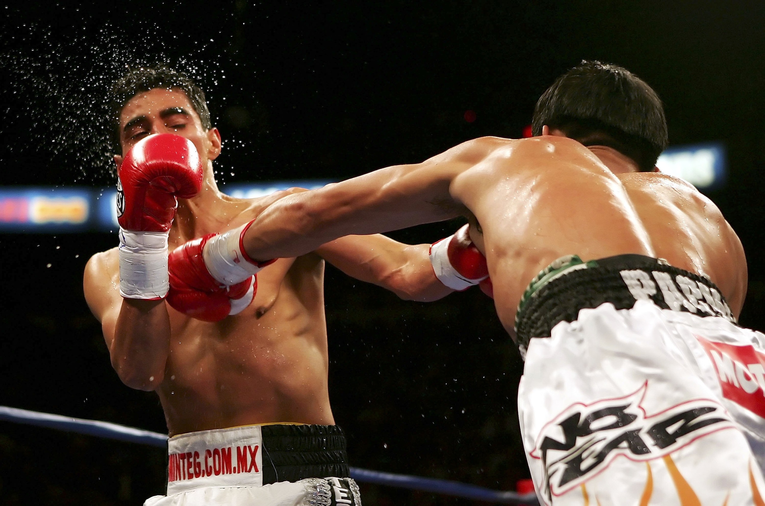 LAS VEGAS - NOVEMBER 18: (R-L) Manny Pacquiao of the Philippines connects with a left to the face of Erik Morales of Mexico during their super featherweight bout at the Thomas & Mack Center on November 18, 2006 in Las Vegas, Nevada. Pacquiao won after a LAS VEGAS - NOVEMBER 18: (R-L) Manny Pacquiao of the Philippines connects with a left to the face of Erik Morales of Mexico during their super featherweight bout at the Thomas & Mack Center on November 18, 2006 in Las Vegas, Nevada. Pacquiao won after a
