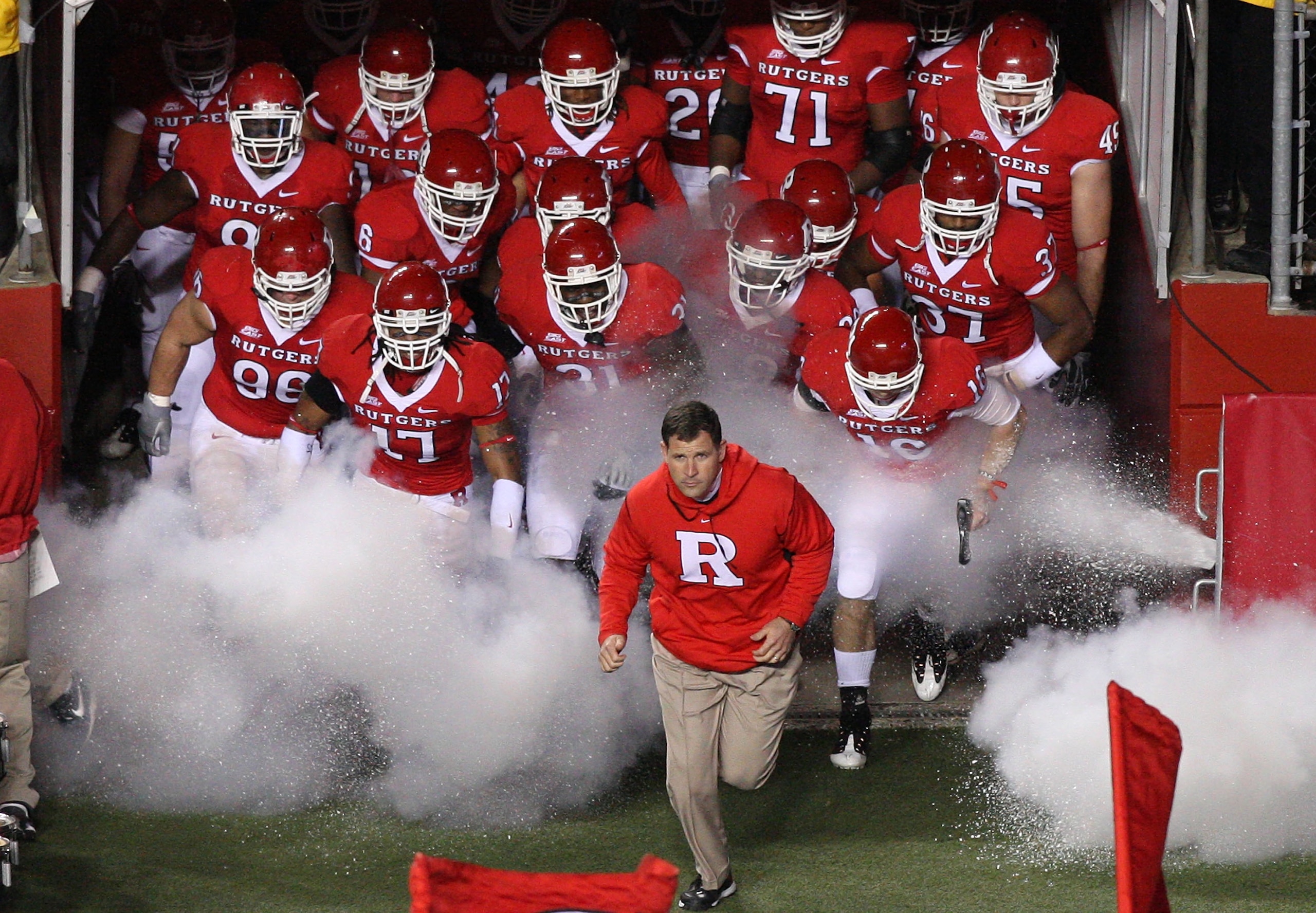 PISCATAWAY, NJ - NOVEMBER 12:  Head coach Greg Schiano of the Rutgers Scarlet Knights leads his team on the field to play against the South Florida Bulls at Rutgers Stadium on November 12, 2009 in Piscataway, New Jersey.  (Photo by Jim McIsaac/Getty Image