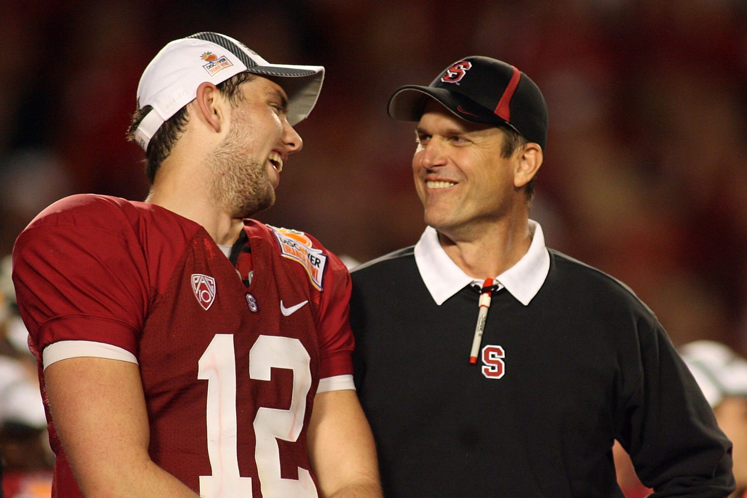 MIAMI, FL - JANUARY 03:  (L-R) Quarterback Andrew Luck and head coach Jim Harbaugh of the Stanford Cardinal celebrate on stage after Stanford won 40-12 against the Virginai Tech Hokies during the 2011 Discover Orange Bowl at Sun Life Stadium on January 3,