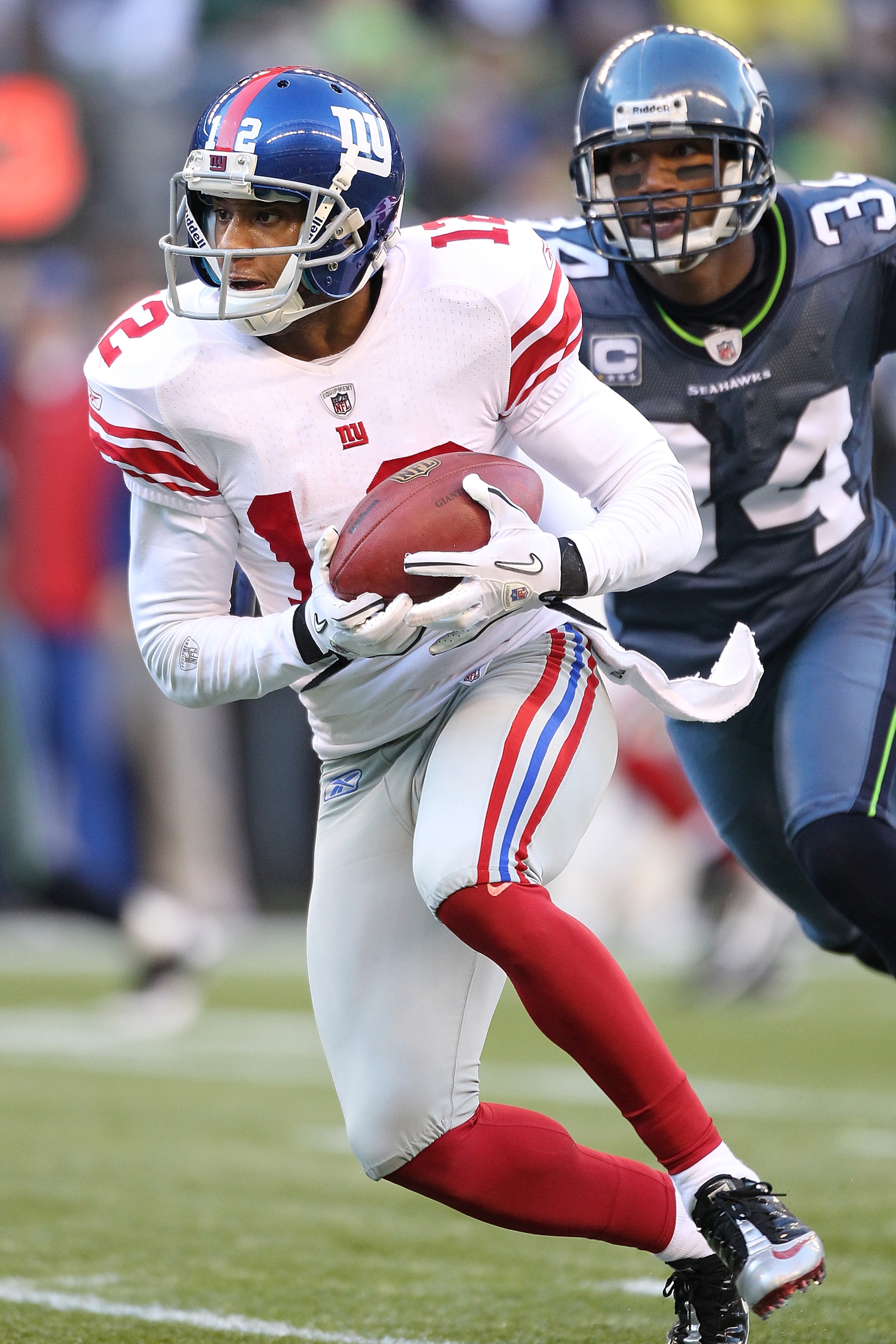 SEATTLE - NOVEMBER 07:  Wide receiver Steve Smith #12 of the New York Giants rushes against Roy Lewis #34 of the Seattle Seahawks at Qwest Field on November 7, 2010 in Seattle, Washington. The Giants defeated the Seahawks 41-7. (Photo by Otto Greule Jr/Ge