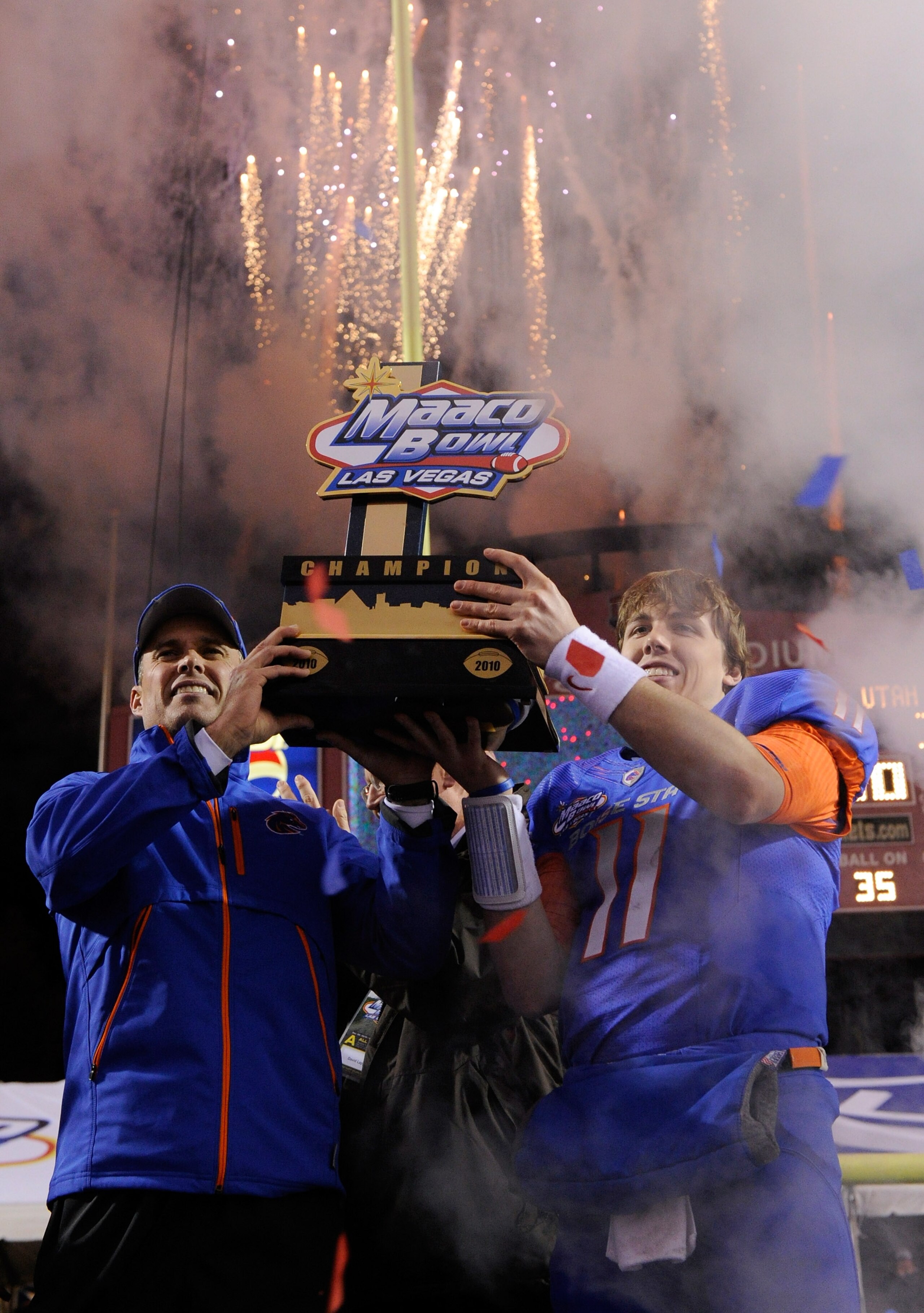 LAS VEGAS, NV - DECEMBER 22: Head coach Chris Petersen (L) and quarterback Kellen Moore #11 of the Boise State Broncos hold up a trophy as they celebrate their 26-3 victory over the Utah Utes in the MAACO Bowl Las Vegas at Sam Boyd Stadium December 22, 2 LAS VEGAS, NV - DECEMBER 22: Head coach Chris Petersen (L) and quarterback Kellen Moore #11 of the Boise State Broncos hold up a trophy as they celebrate their 26-3 victory over the Utah Utes in the MAACO Bowl Las Vegas at Sam Boyd Stadium December 22, 2