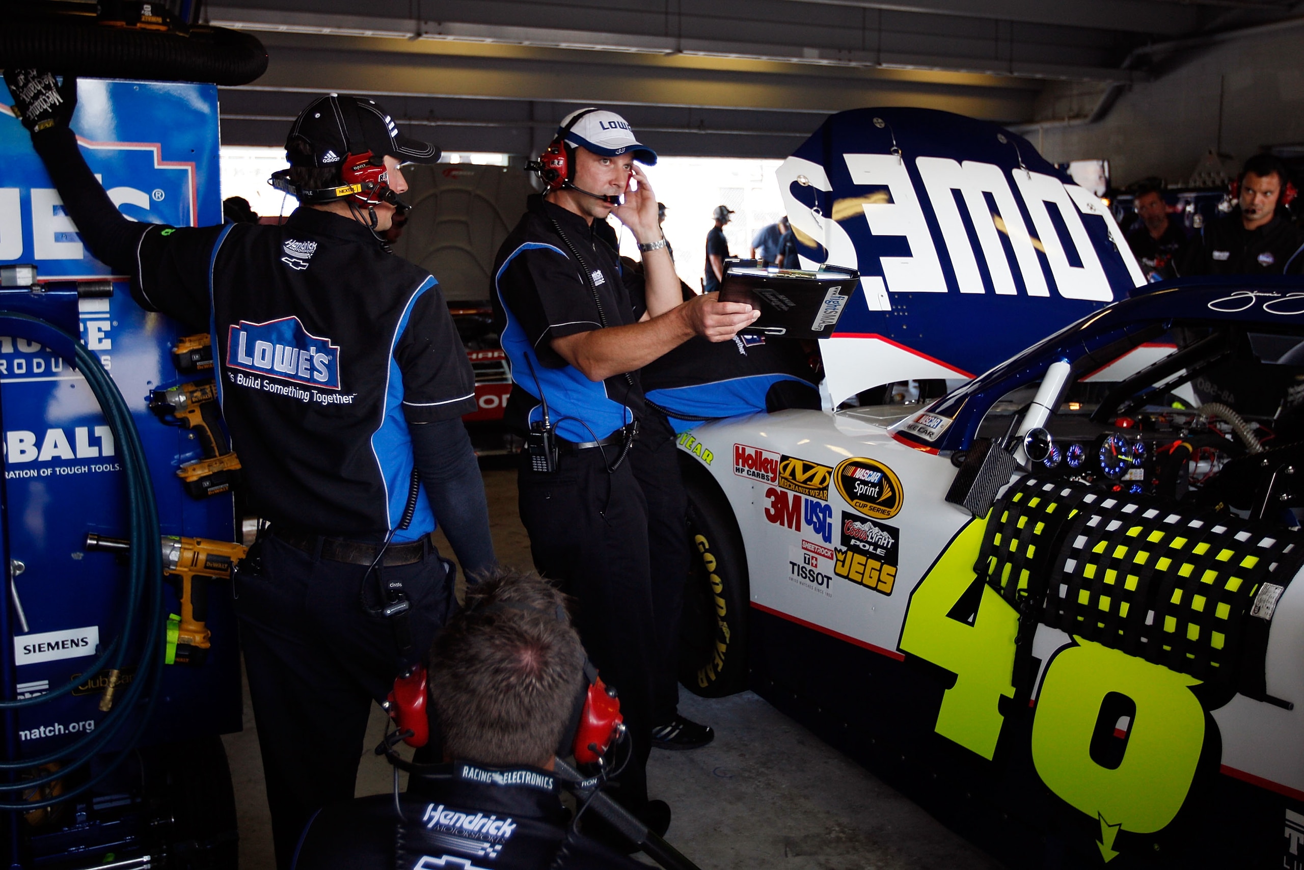 HOMESTEAD, FL - NOVEMBER 20:  Chad Knaus, crew chief of the #48 Lowe's Chevrolet, looks over the car in the garage during practice for the NASCAR Sprint Cup Series Ford 400 at Homestead-Miami Speedway on November 20, 2010 in Homestead, Florida.  (Photo by
